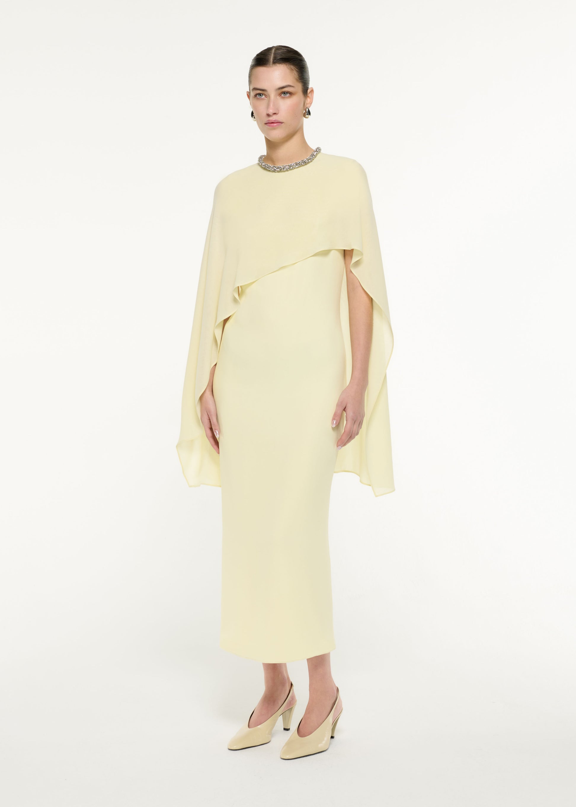 Side view of a model wearing the Silk Cape Maxi Dress in Light Yellow
