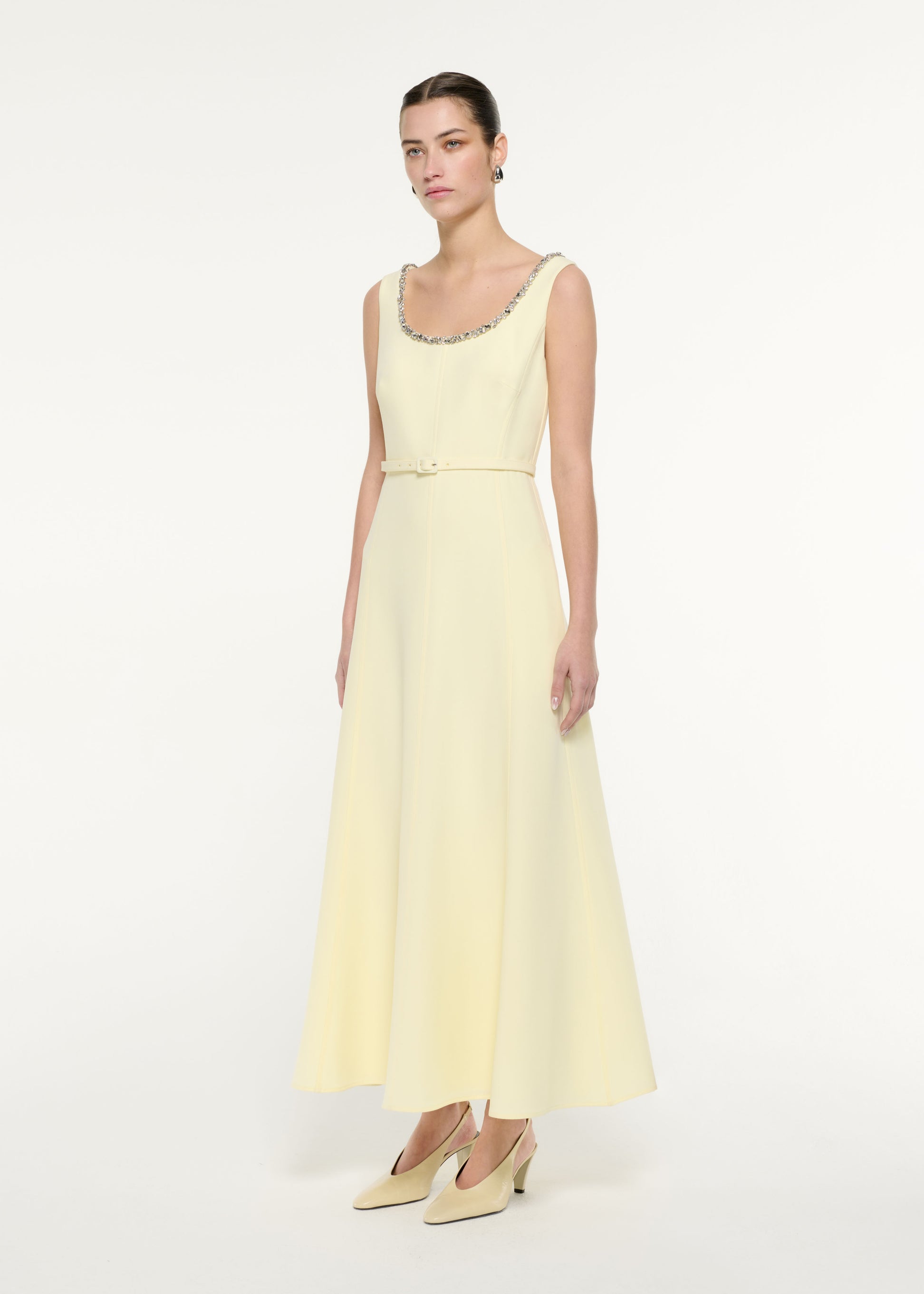 Side view of a model wearing the Embellished Heavy Cady Maxi Dress in Light Yellow