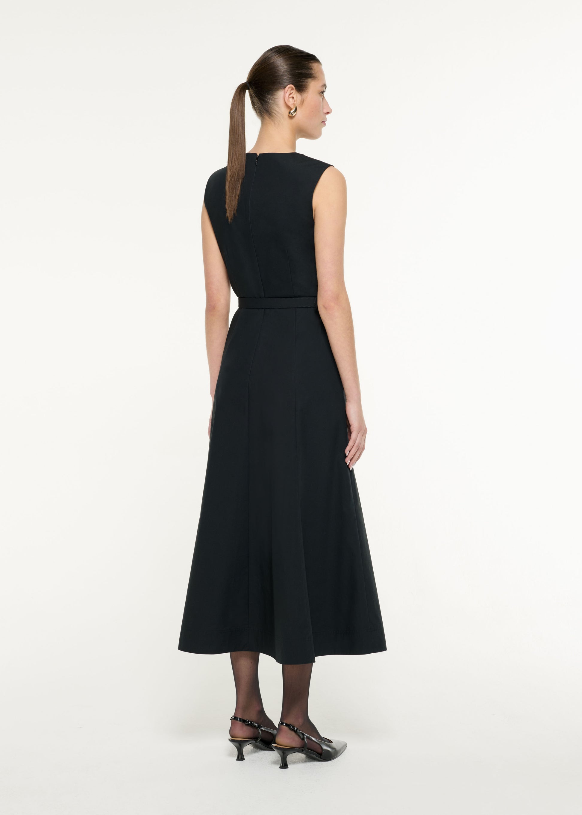 Back view of a model wearing the Drape Cotton Poplin Midi Dress in Black
