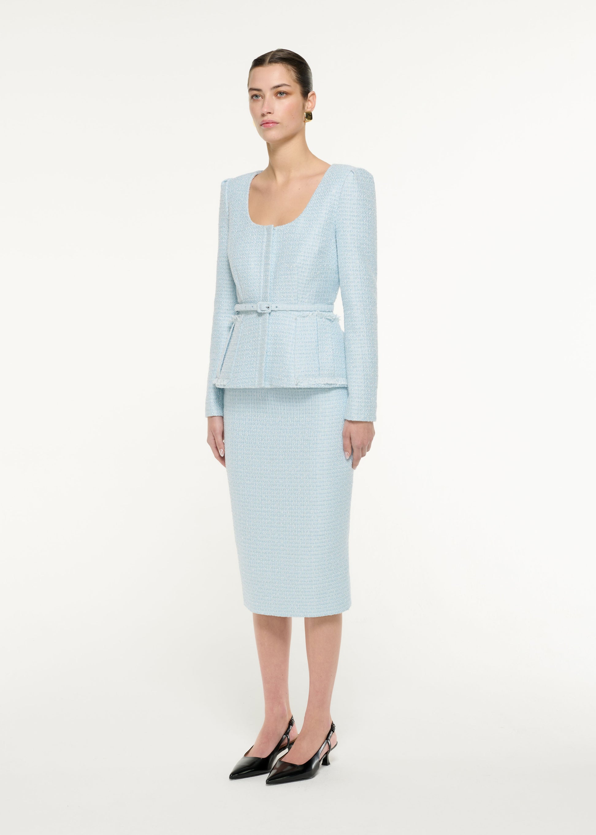 Side view of a model wearing the Boucle Jacket in Blue