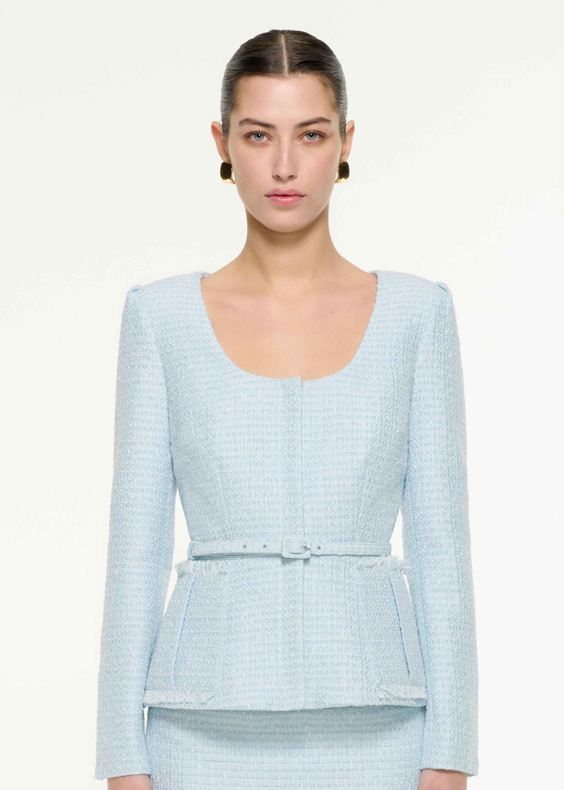 Close up of a model wearing the Boucle Jacket in Blue