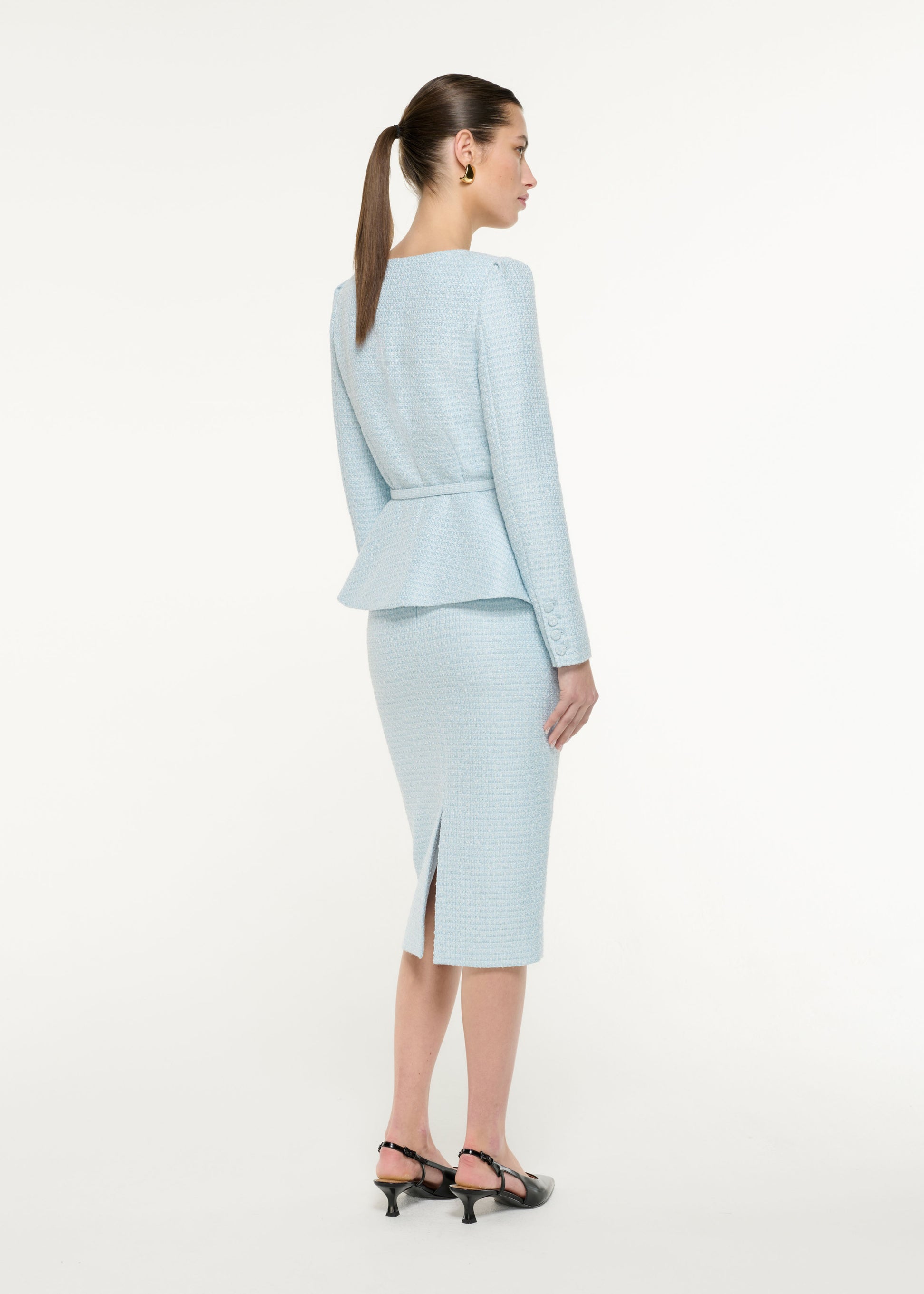 Back view of a model wearing the Boucle Midi Skirt in Blue