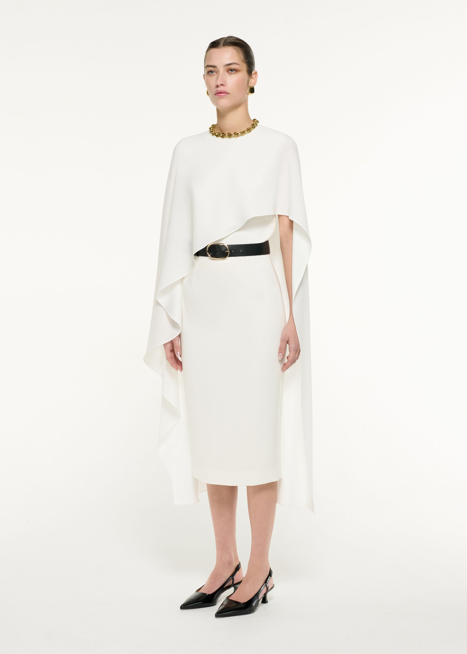 Side view of a model wearing the Pencil Midi Skirt in Cream