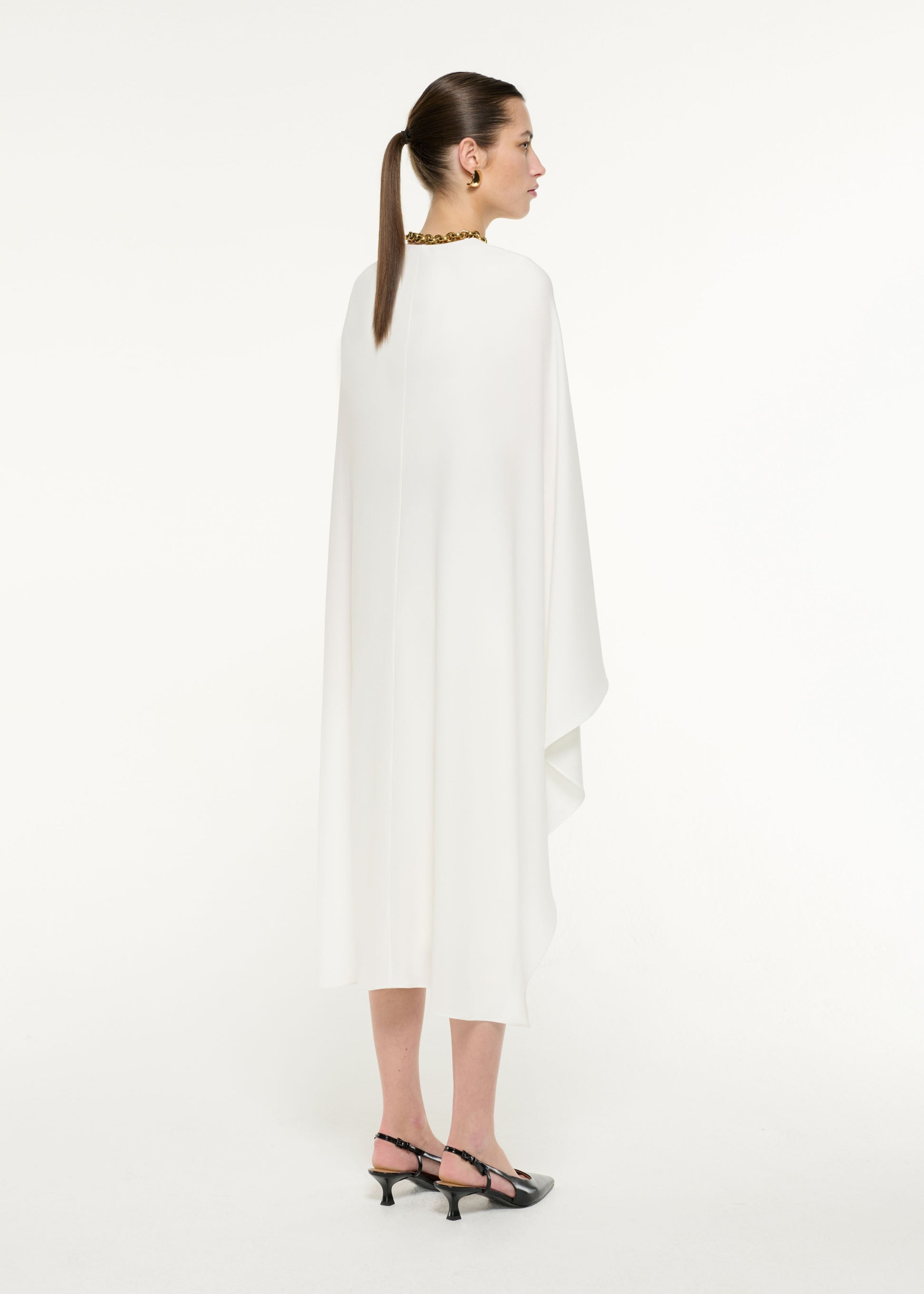 Back view of a model wearing the Pencil Midi Skirt in Cream