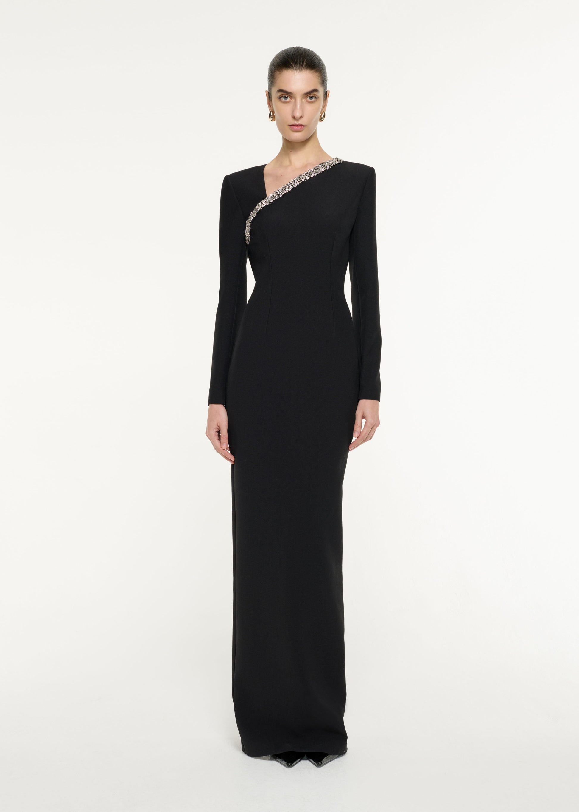 Front view of a model wearing the Embellished Asymmetric Crepe Gown in Black