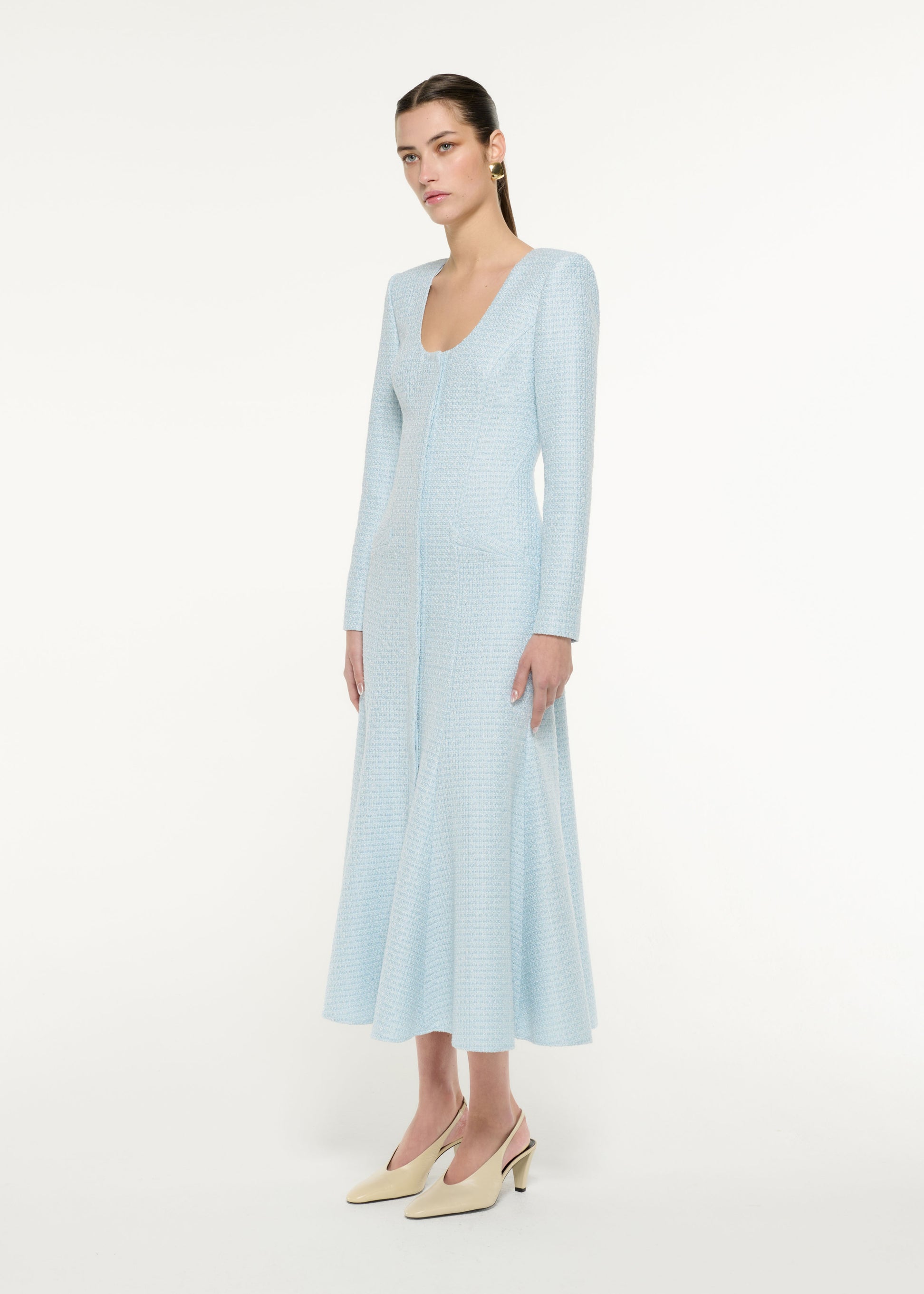 Side view of a model wearing the Boucle Midi Dress in blue