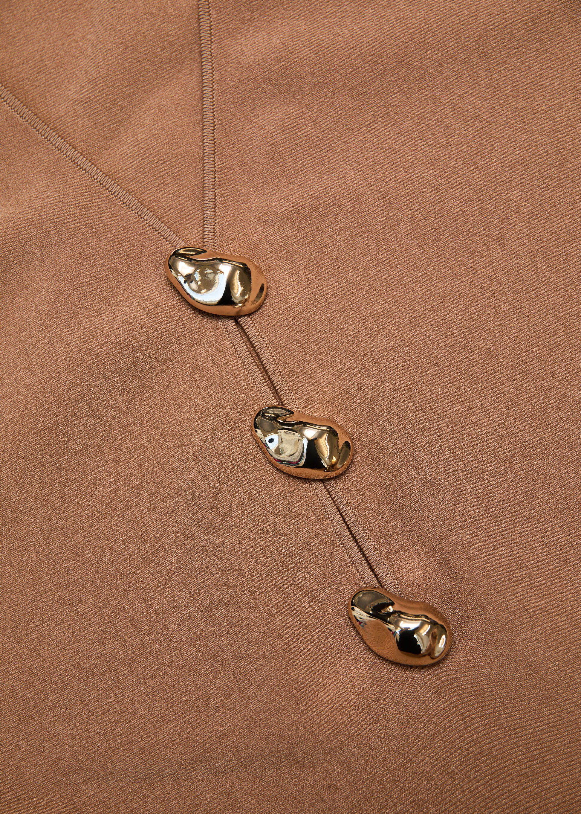 A close up of the fabric for the Pebble Trimmed Knit Dress in Camel