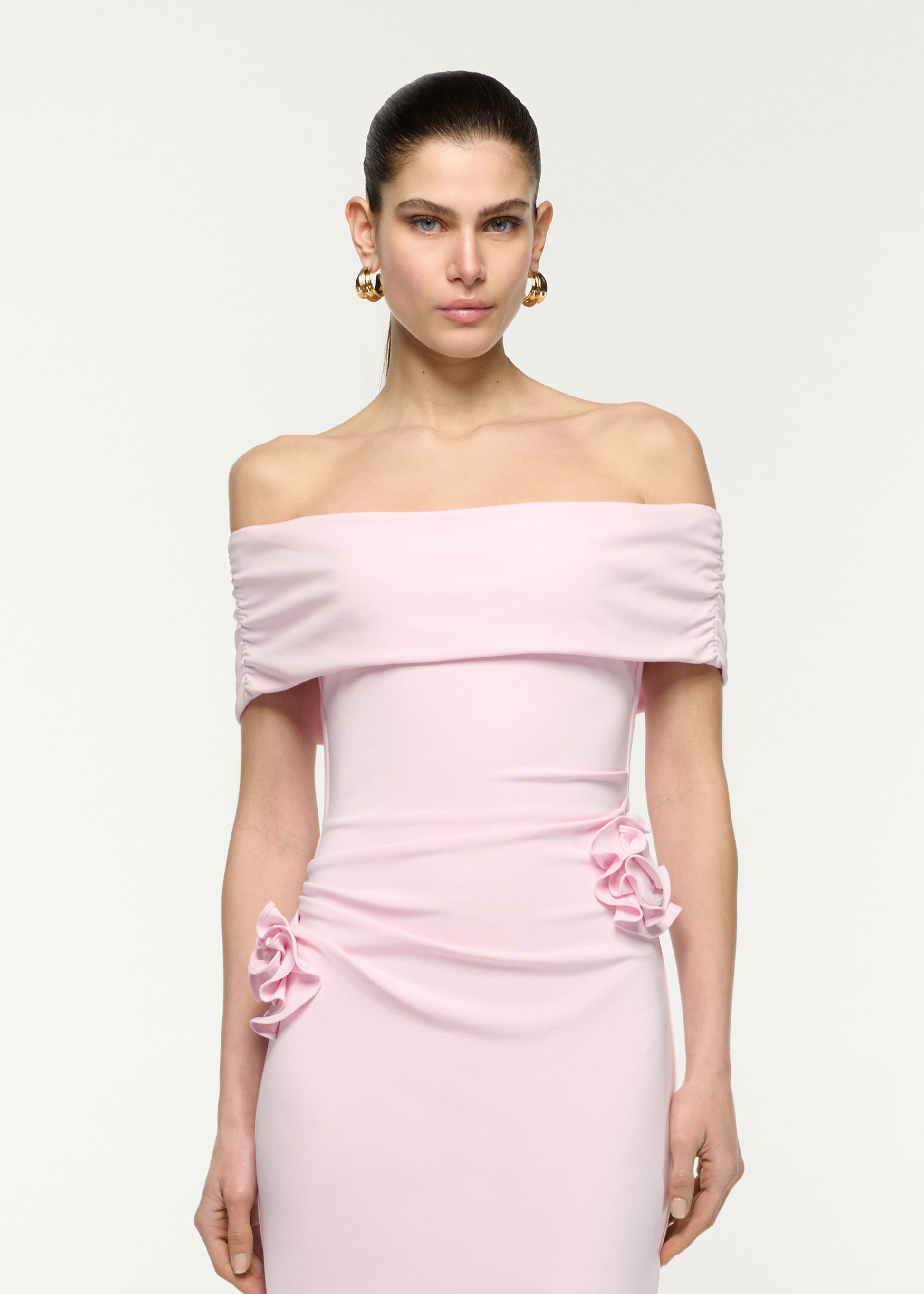 Close up of a model wearing the Off The Shoulder Flower Jersey Dress in Pink