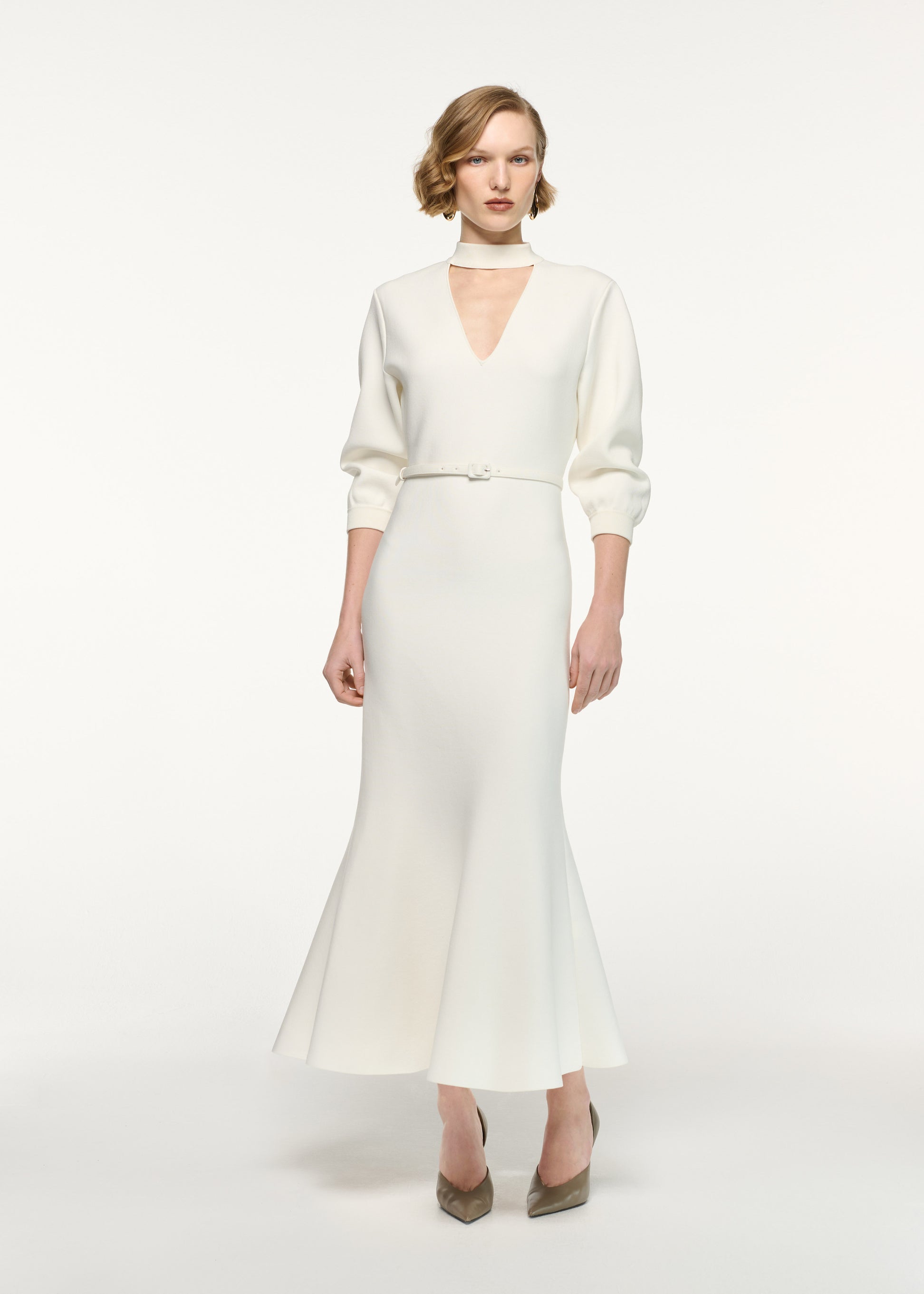 Front view of a model wearing the Belted Blouson Knit Midi Dress in Cream