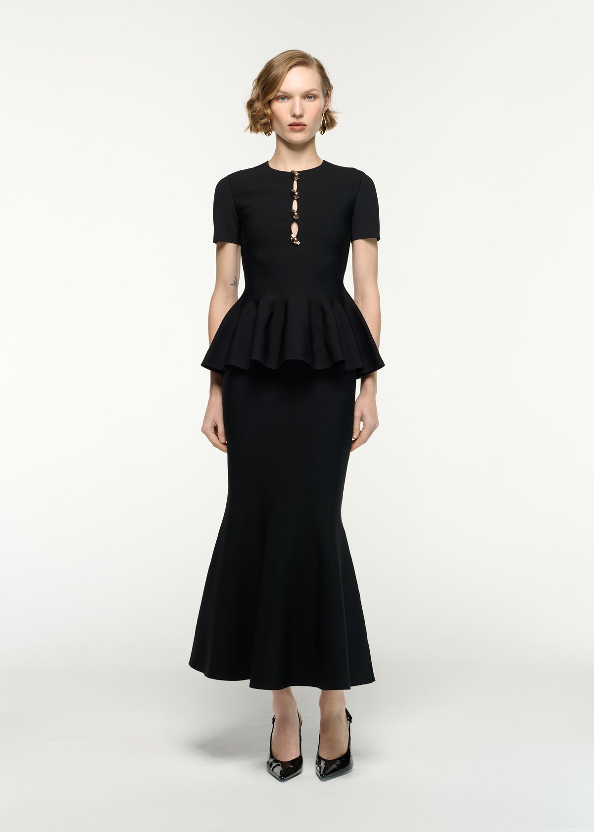 Front view of a model wearing the Mermaid Knit Midi Skirt in Black