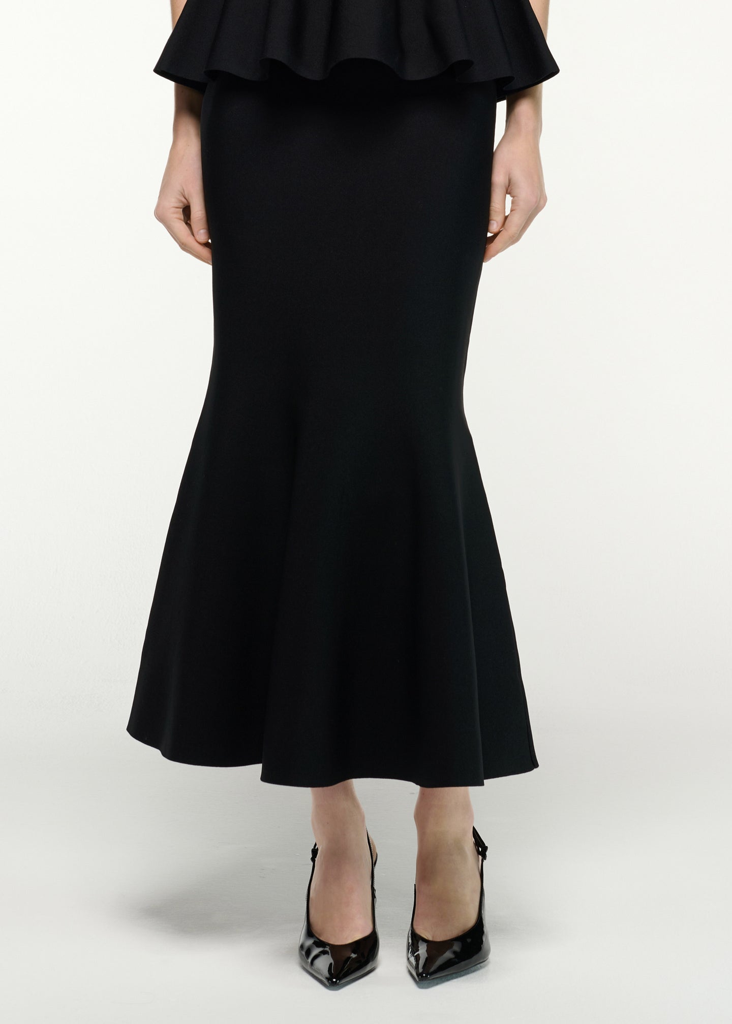 Close up of a model wearing the Mermaid Knit Midi Skirt in Black