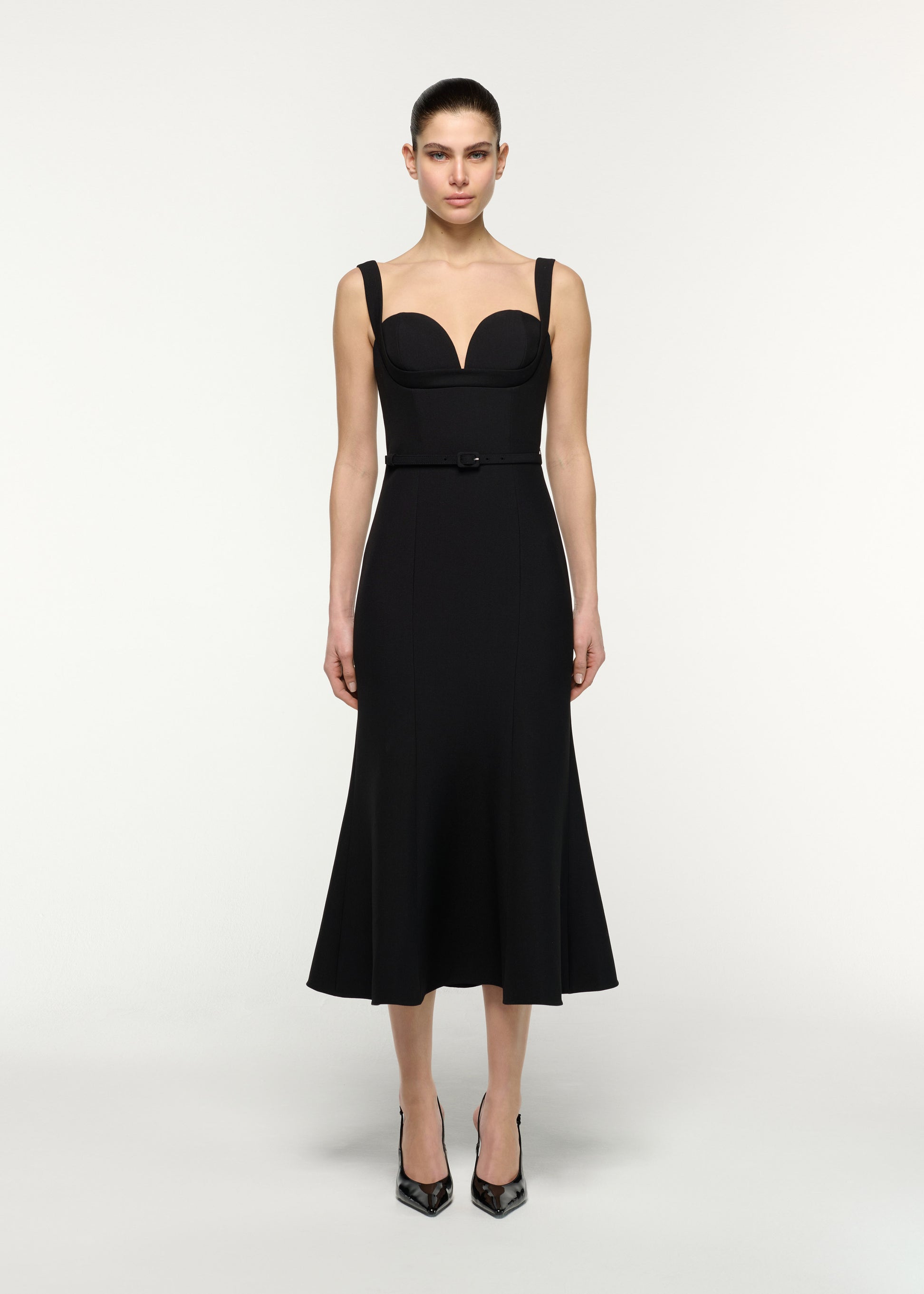 Front view of a model wearing the Belted Fit And Flare Midi Dress in Black