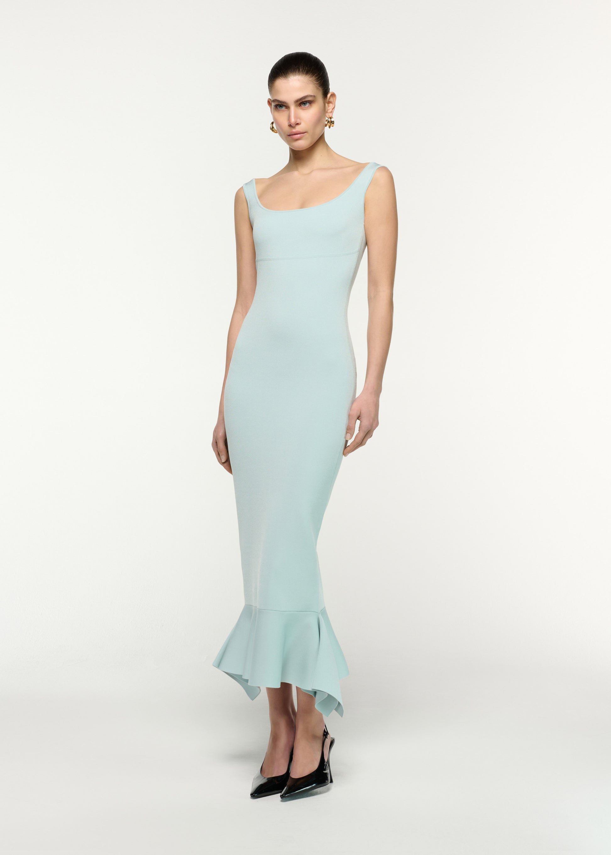 Side view of a model wearing the Fit And Flare Knit Midi Dress in Aqua