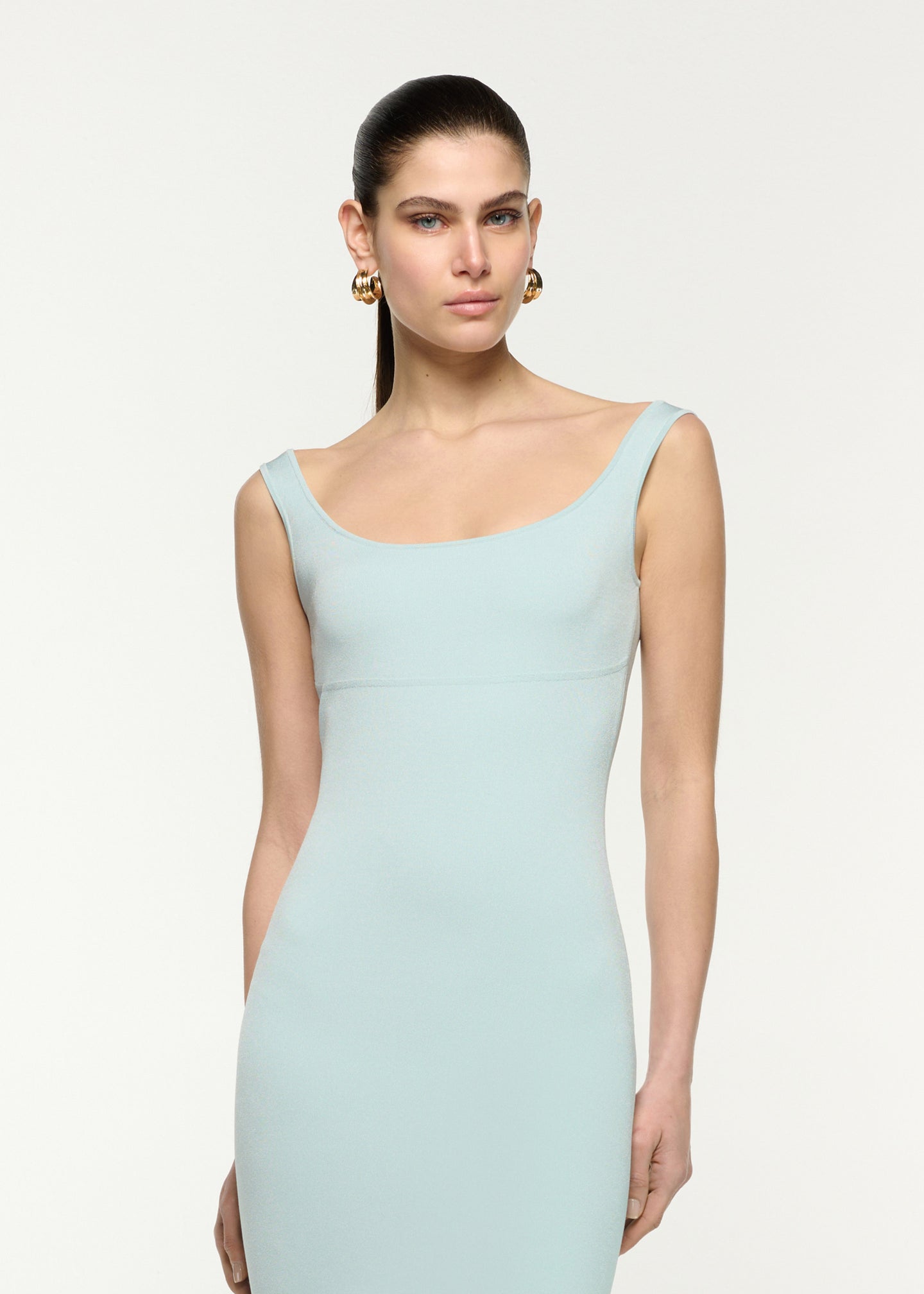 Close up of a model wearing the Fit And Flare Knit Midi Dress in Aqua