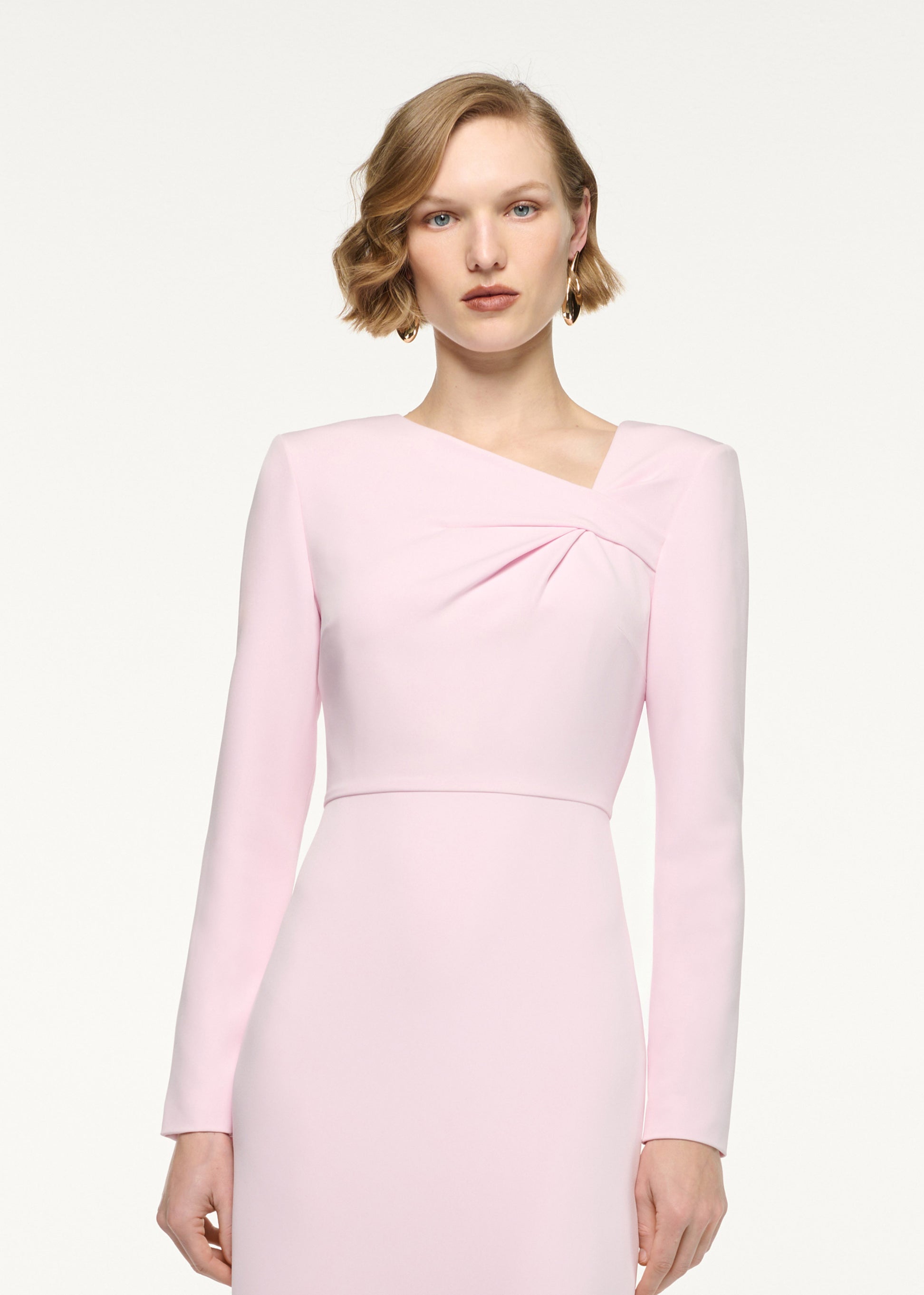 Close up of a model wearing the Asymmetric Twist Drape Midi Dress in Pink