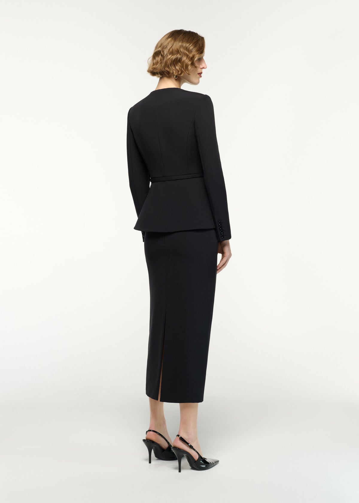 Back view of a model wearing the Flower Belted Jacket in Black