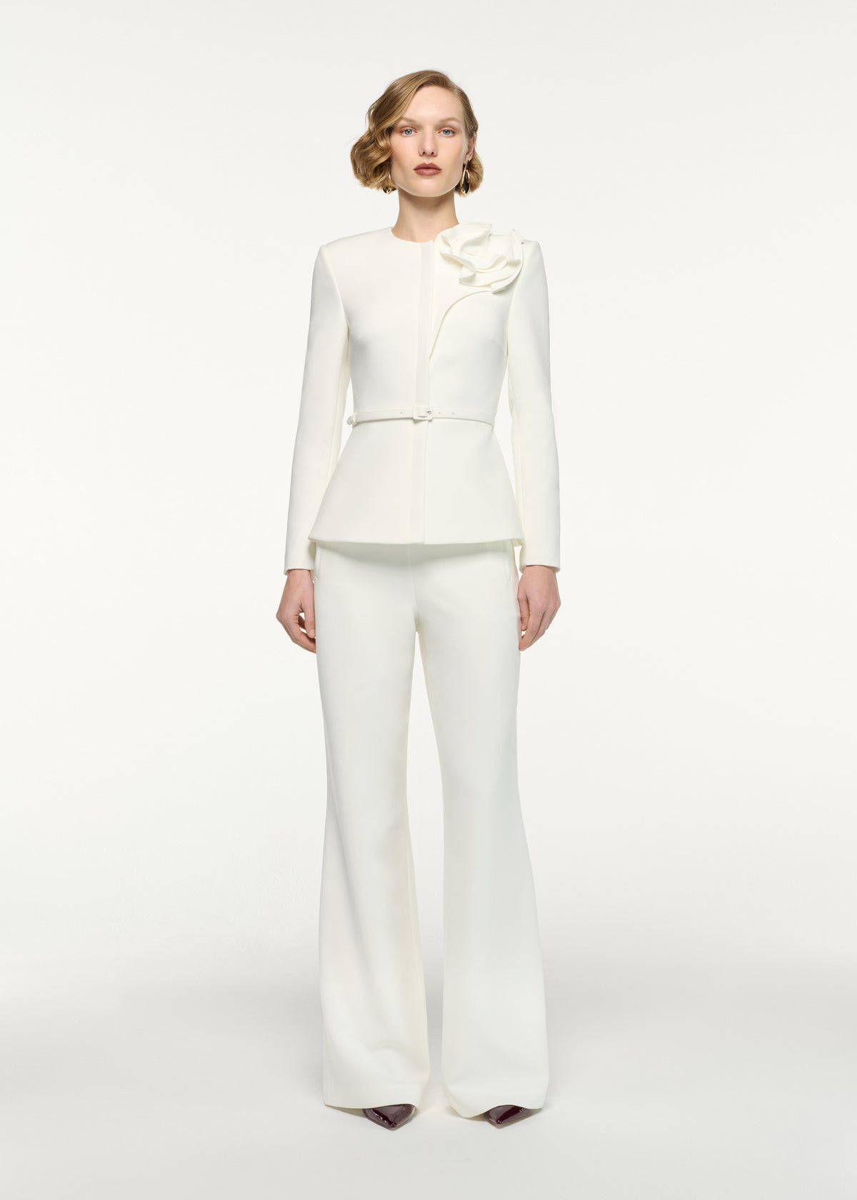Front view of a model wearing the Flower Belted Jacket in Cream
