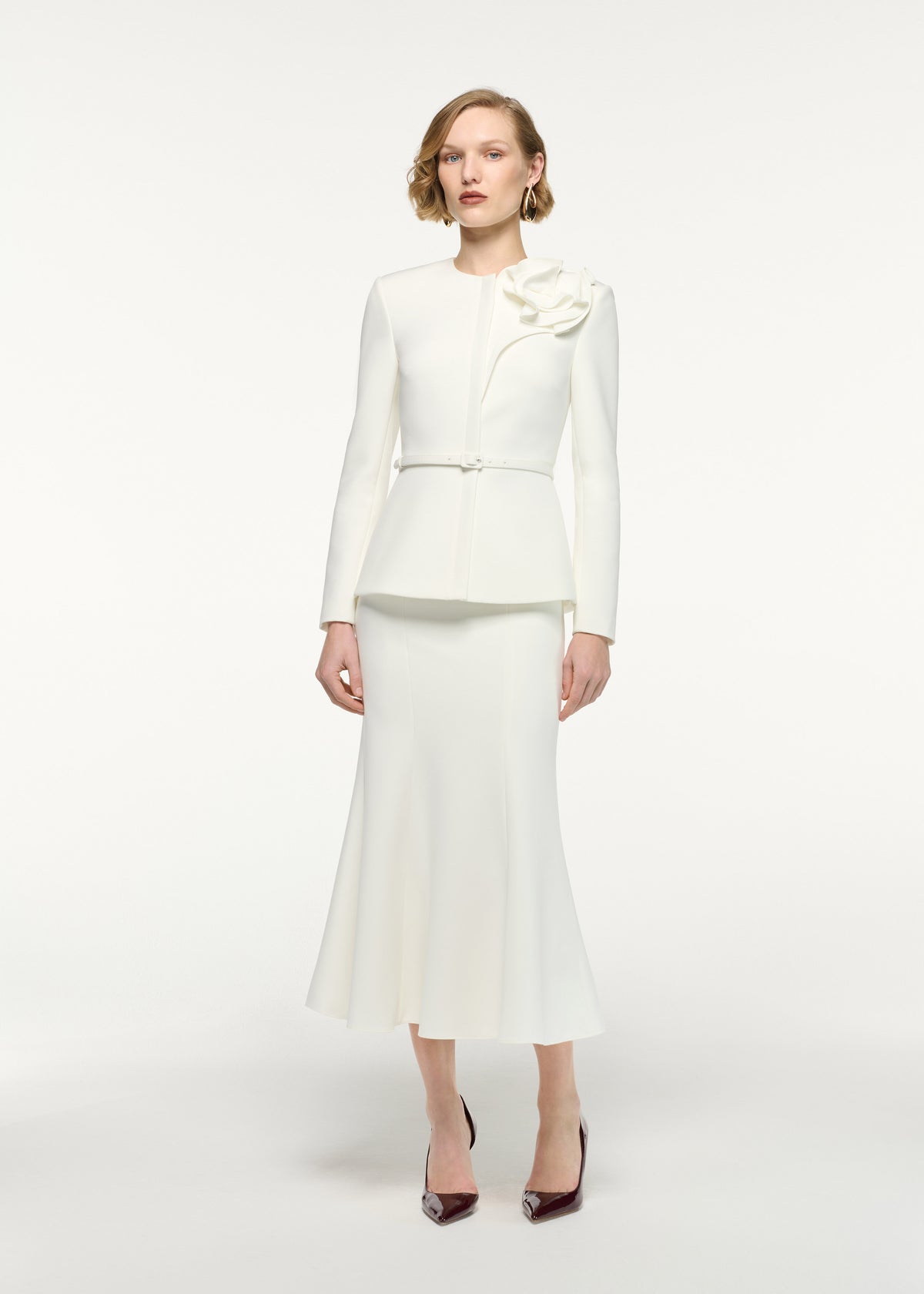 Front view of a model wearing the Fit And Flare Midi Skirt in Cream