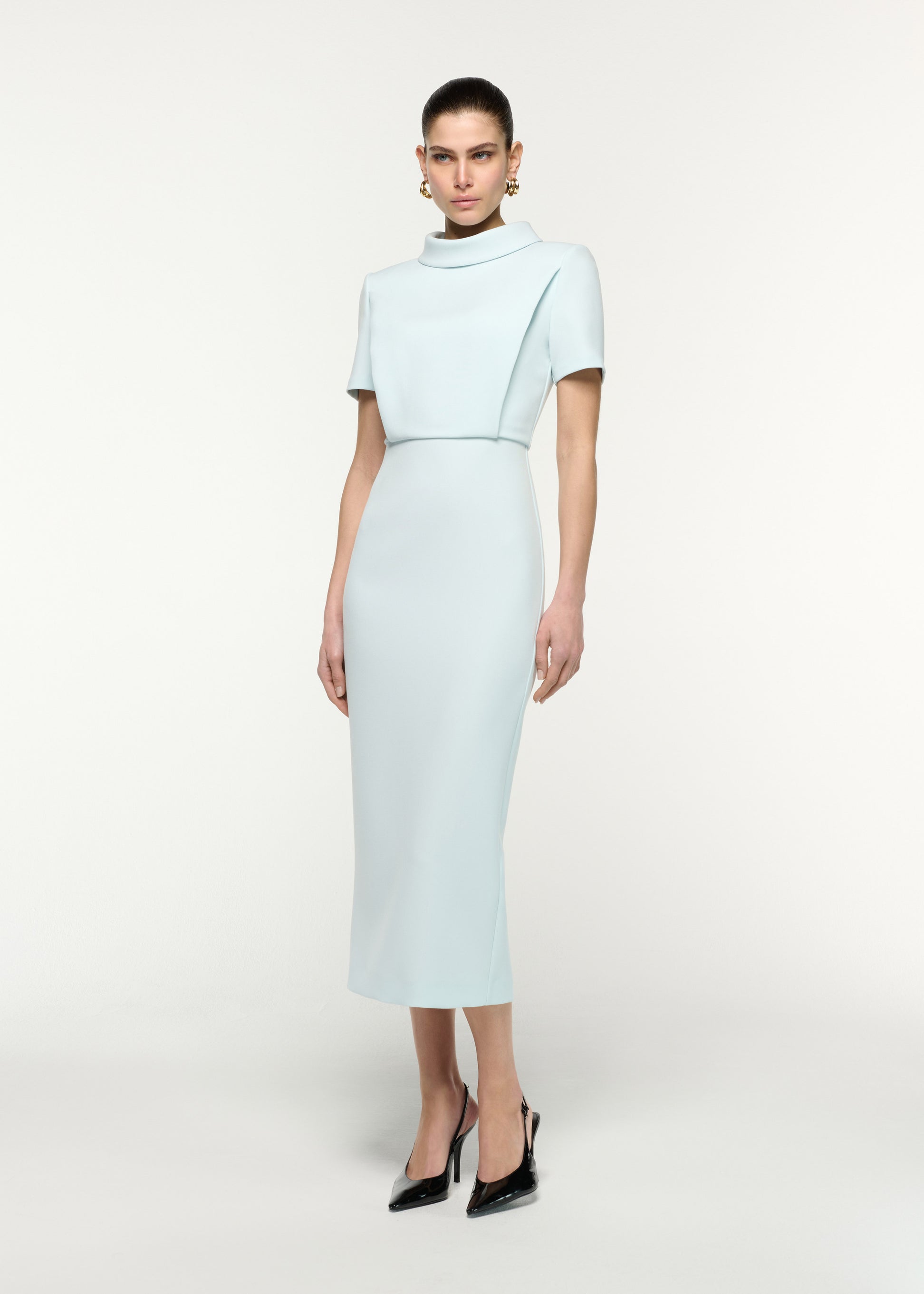 Side view of a model wearing the Collared Crepe Column Midi Dress in Aqua