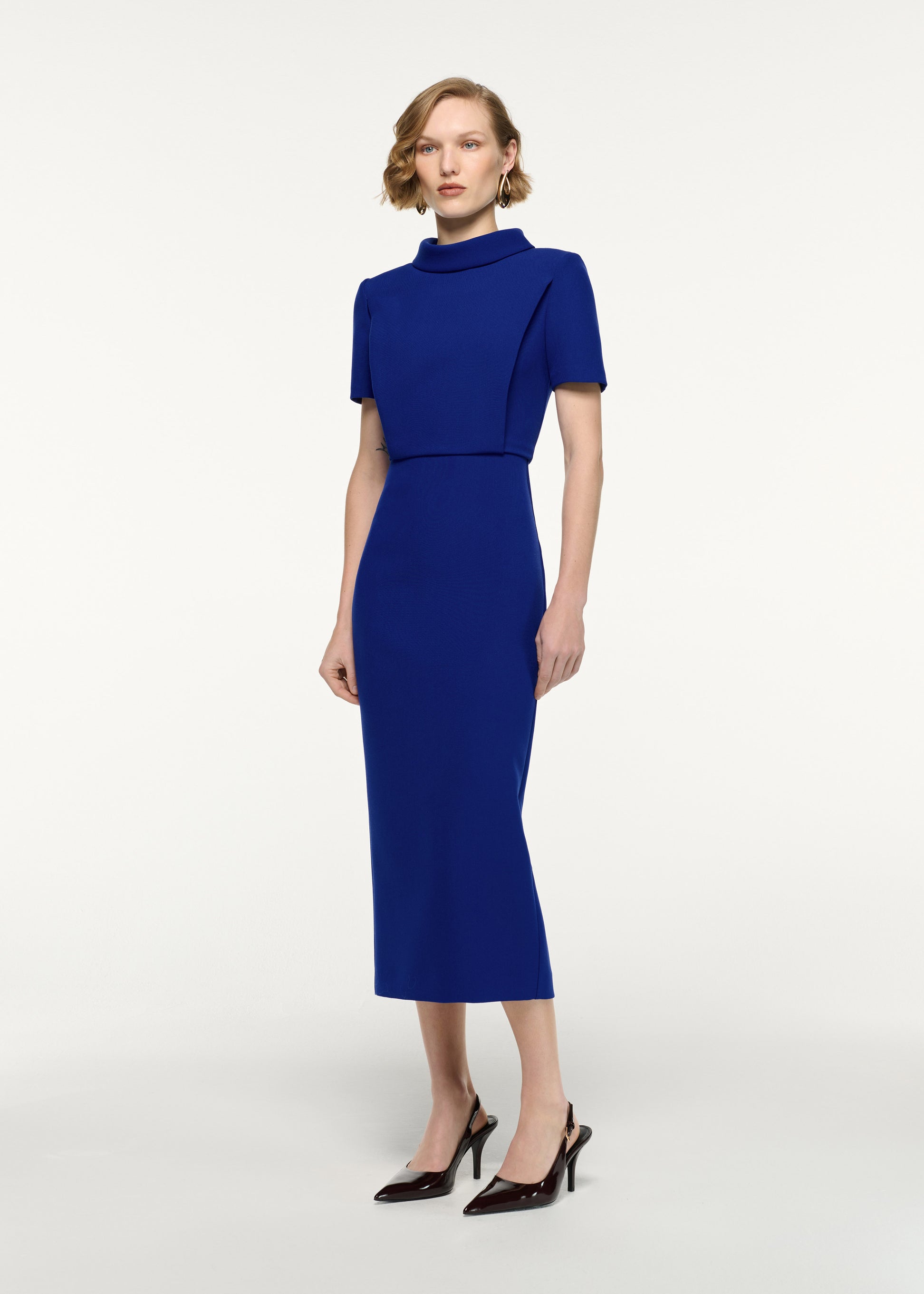 Side view of a model wearing the Collared Crepe Column Midi Dress in Blue