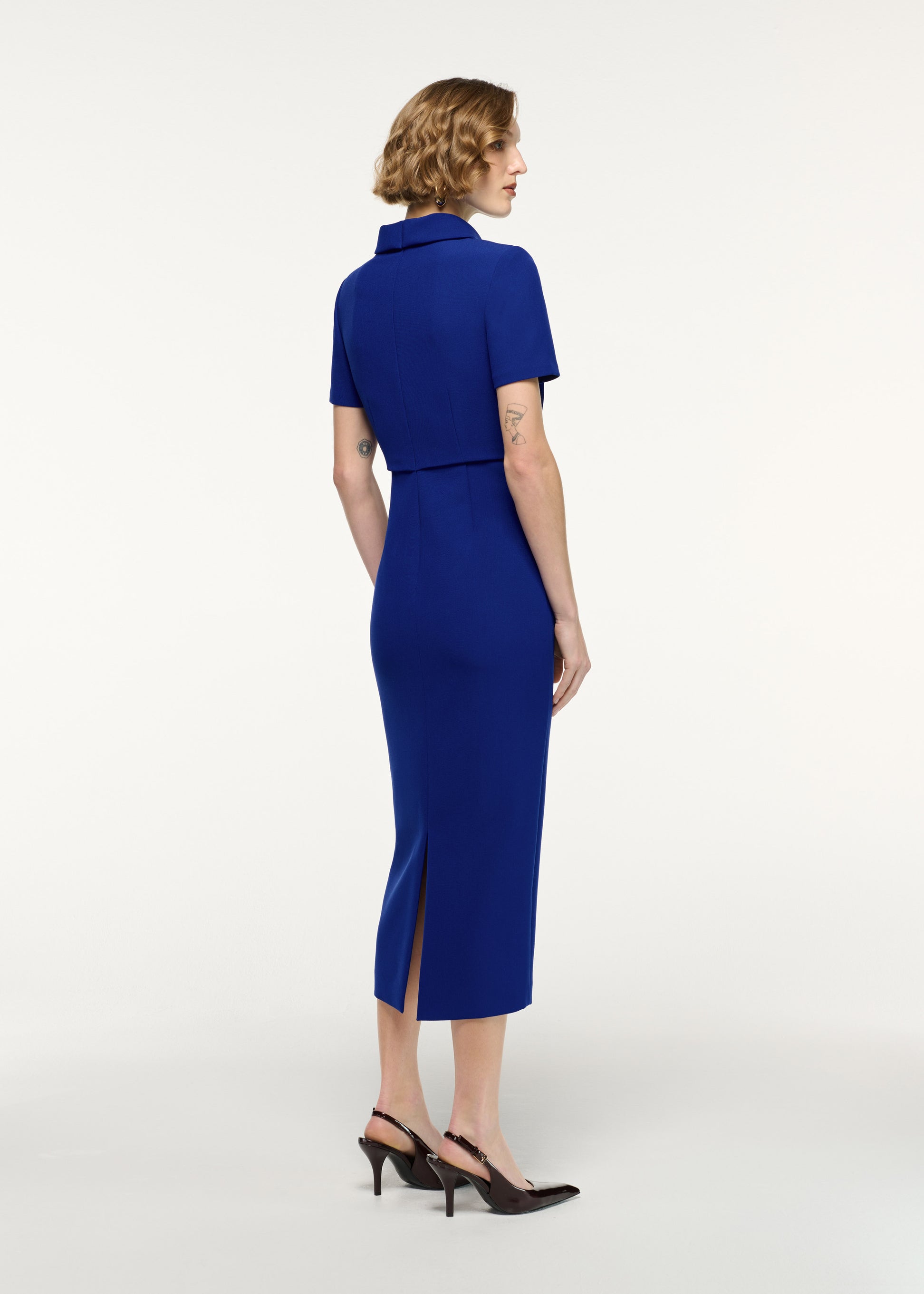 Back view of a model wearing the Collared Crepe Column Midi Dress in Blue