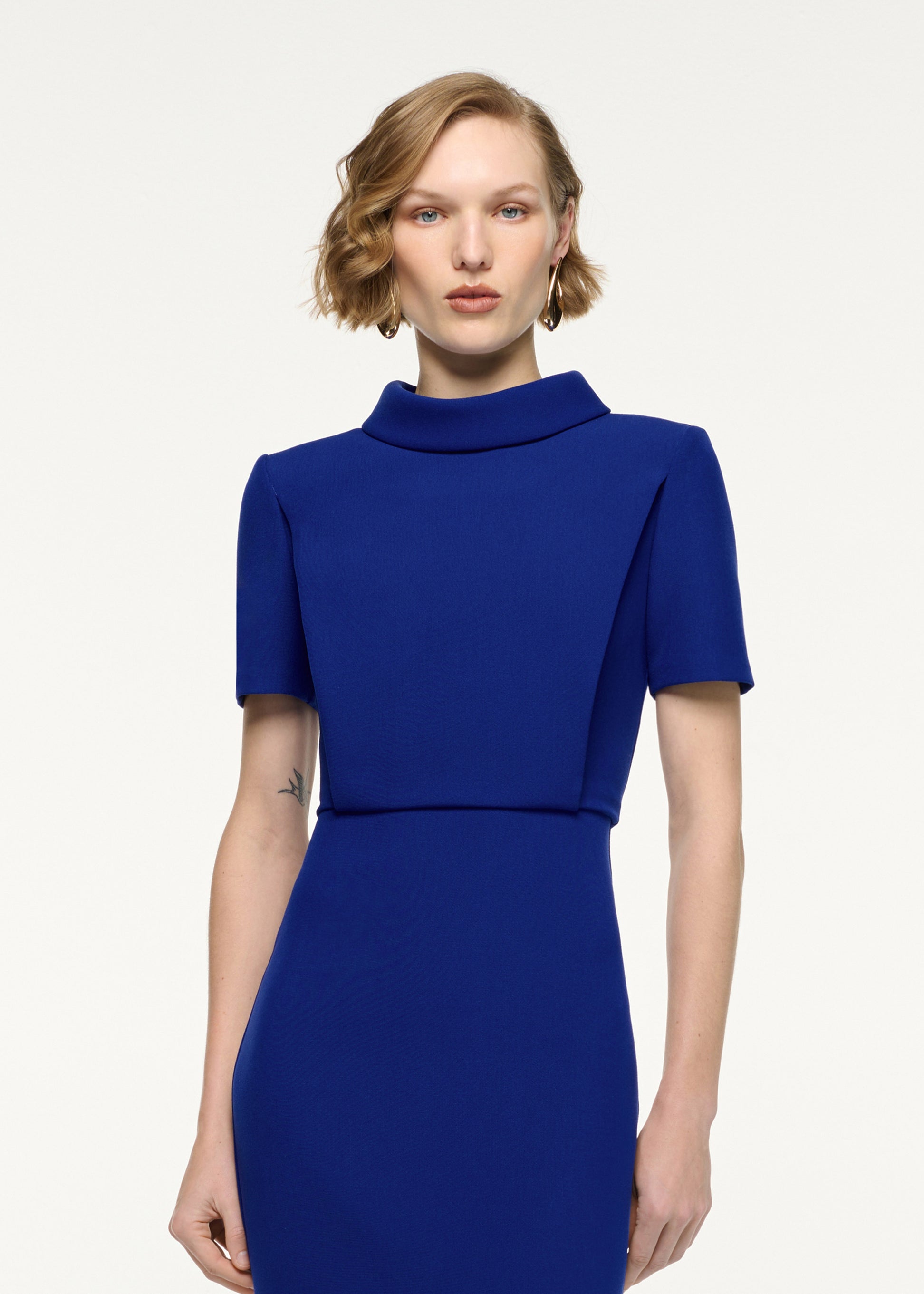 Close up of a model wearing the Collared Crepe Column Midi Dress in Blue