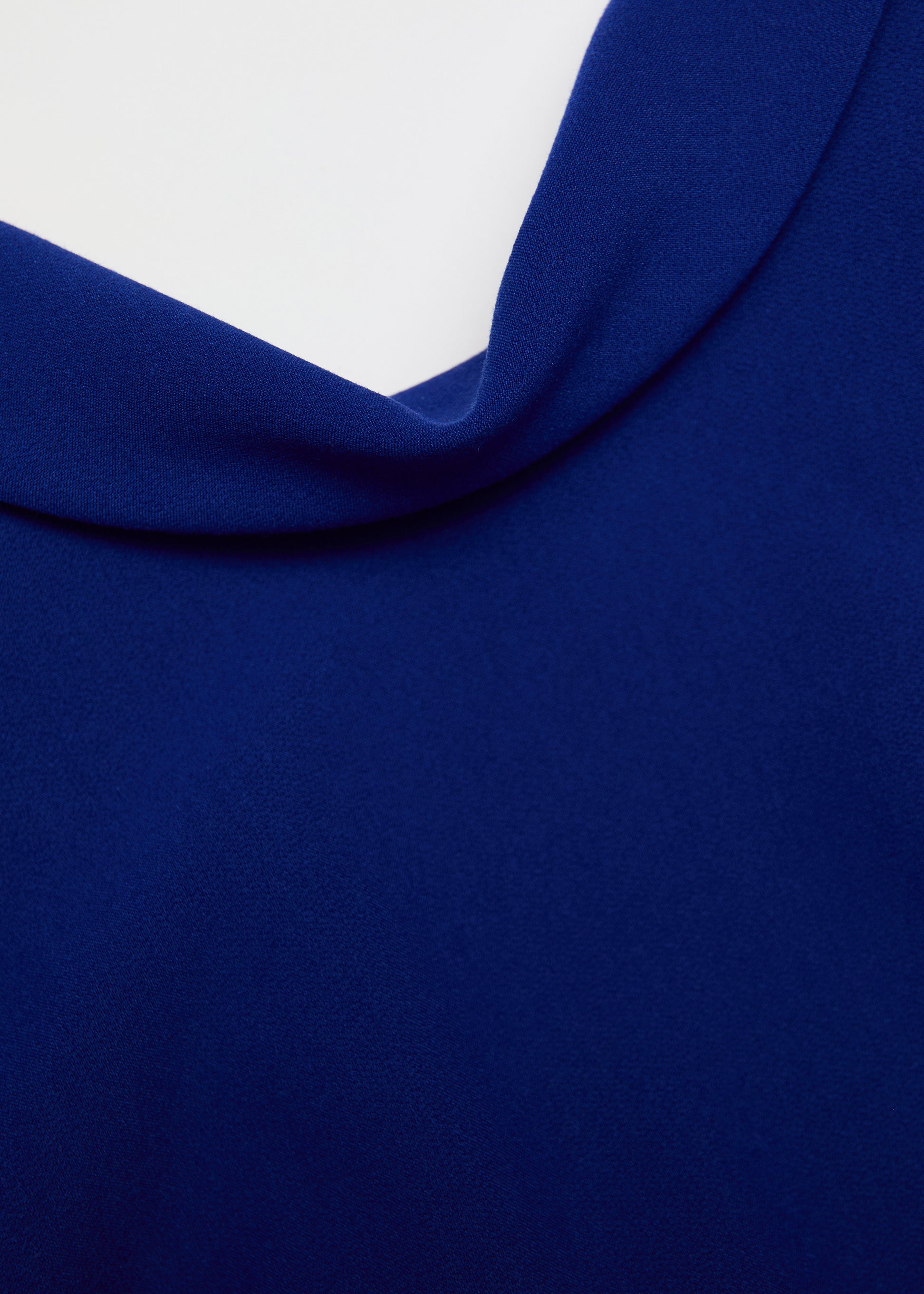A close up of the fabric for the Collared Crepe Column Midi Dress in Blue