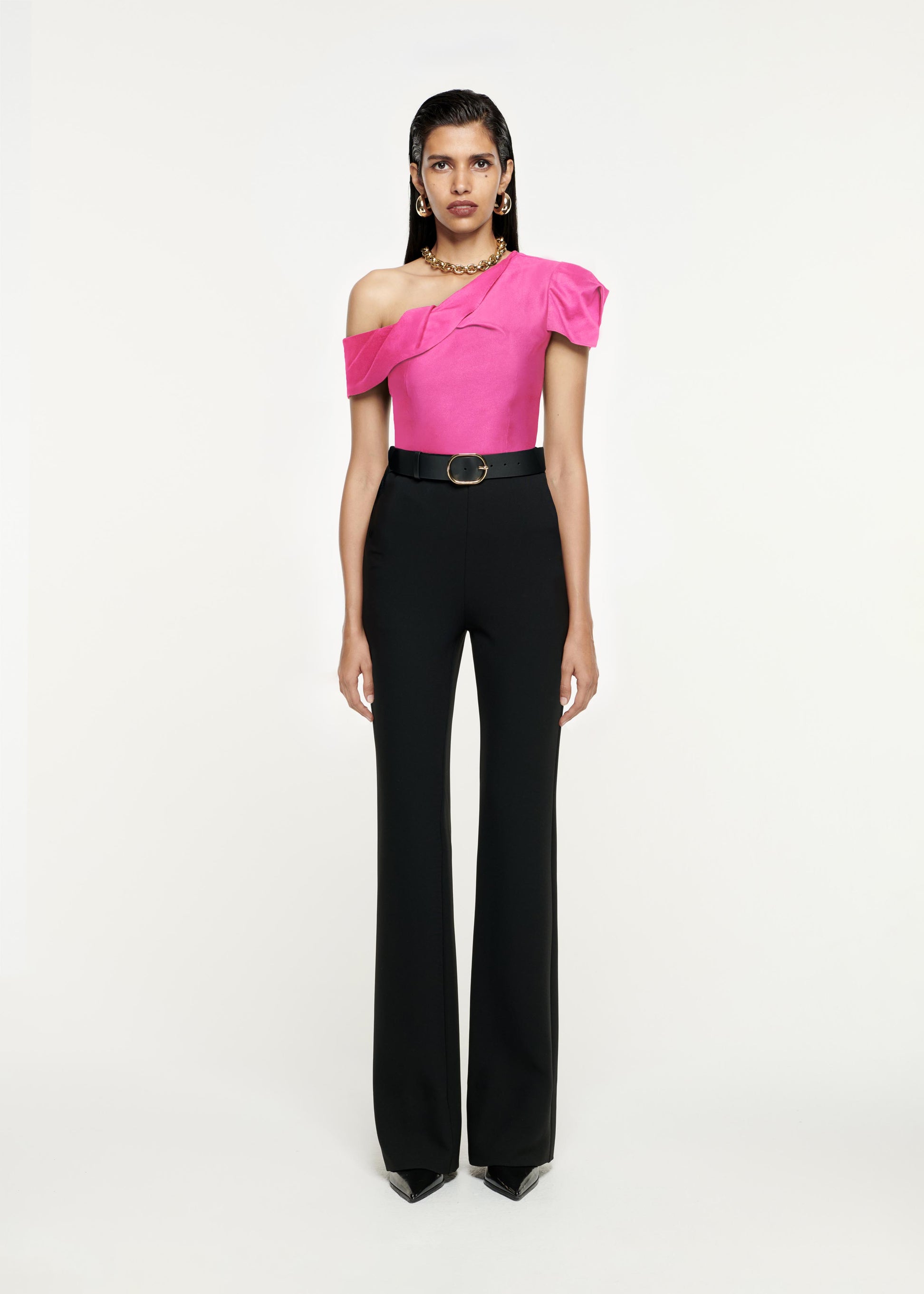 Front view of a model wearing the Asymmetric Stretch-Cady Top in Pink