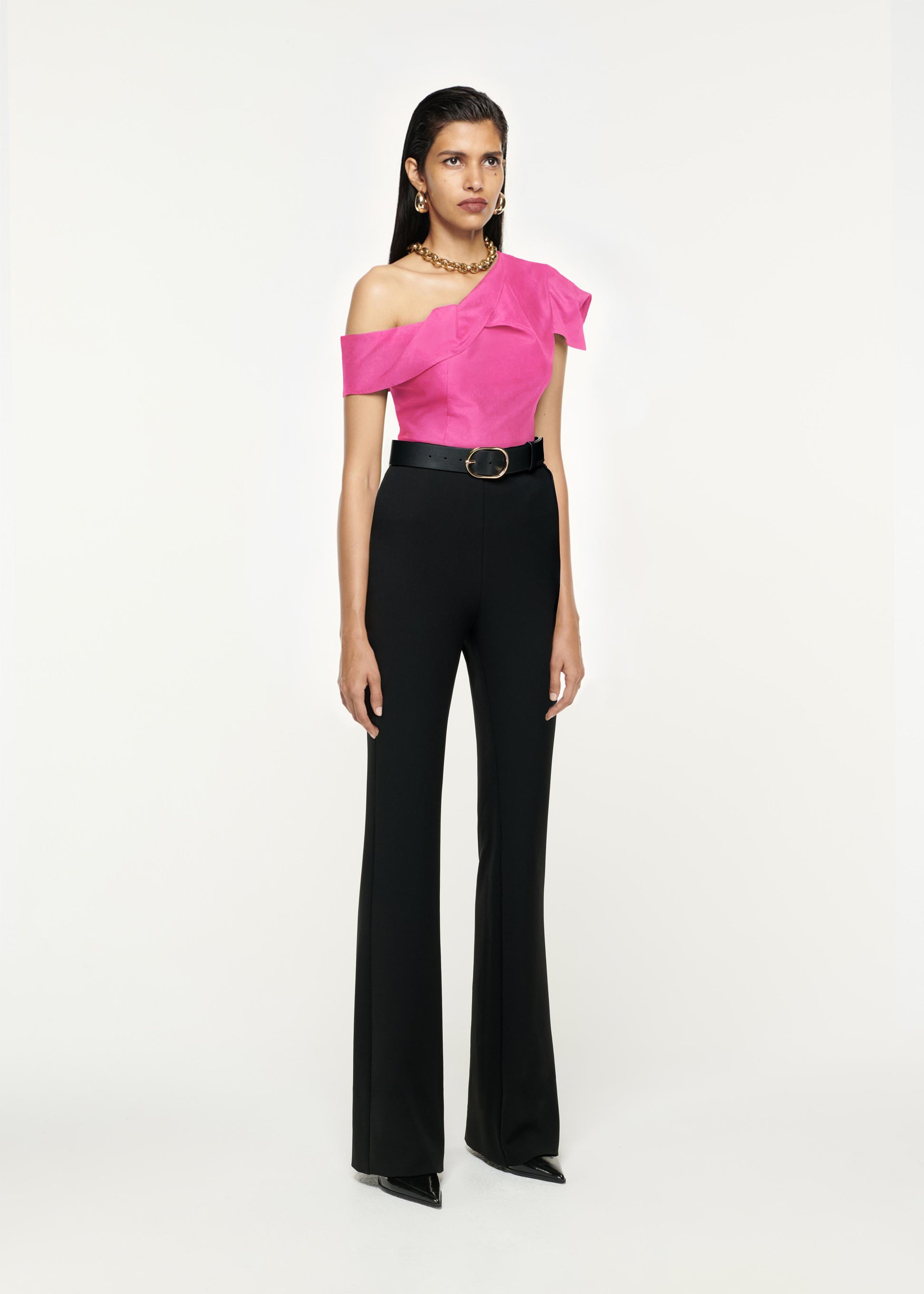 Side view of a model wearing the Asymmetric Stretch-Cady Top in Pink