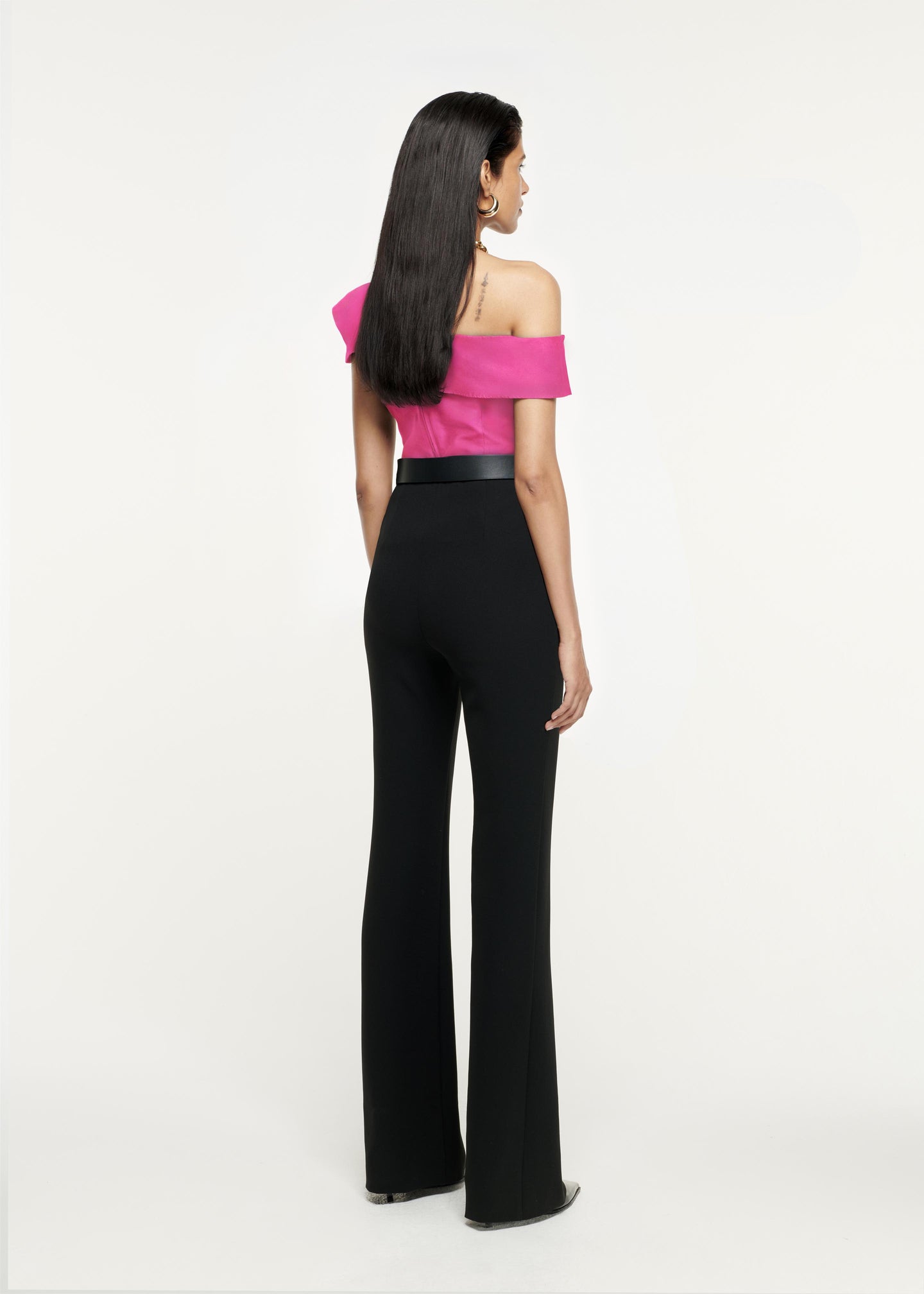 Back view of a model wearing the Asymmetric Stretch-Cady Top in Pink