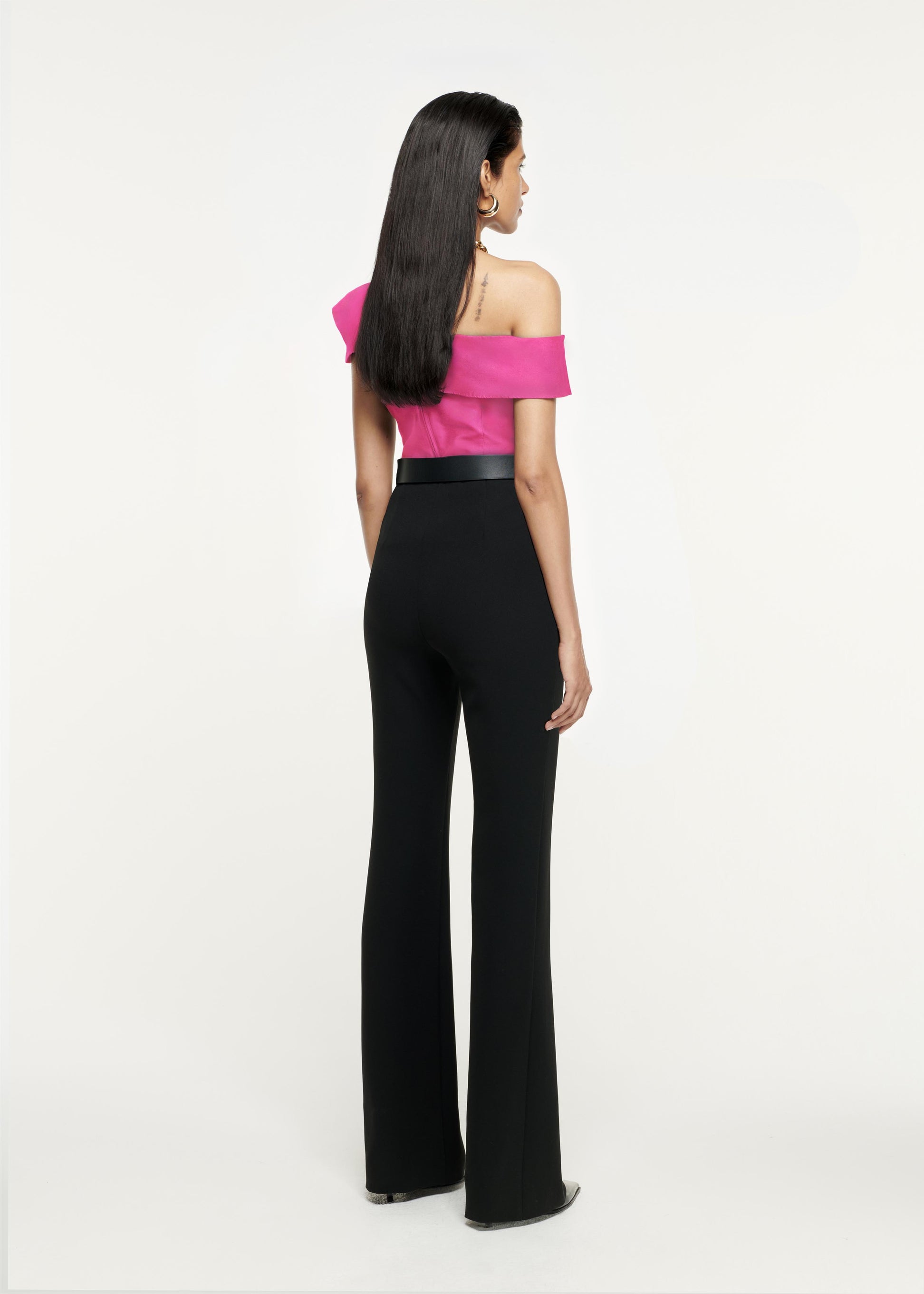 Back view of a model wearing the Asymmetric Stretch-Cady Top in Pink