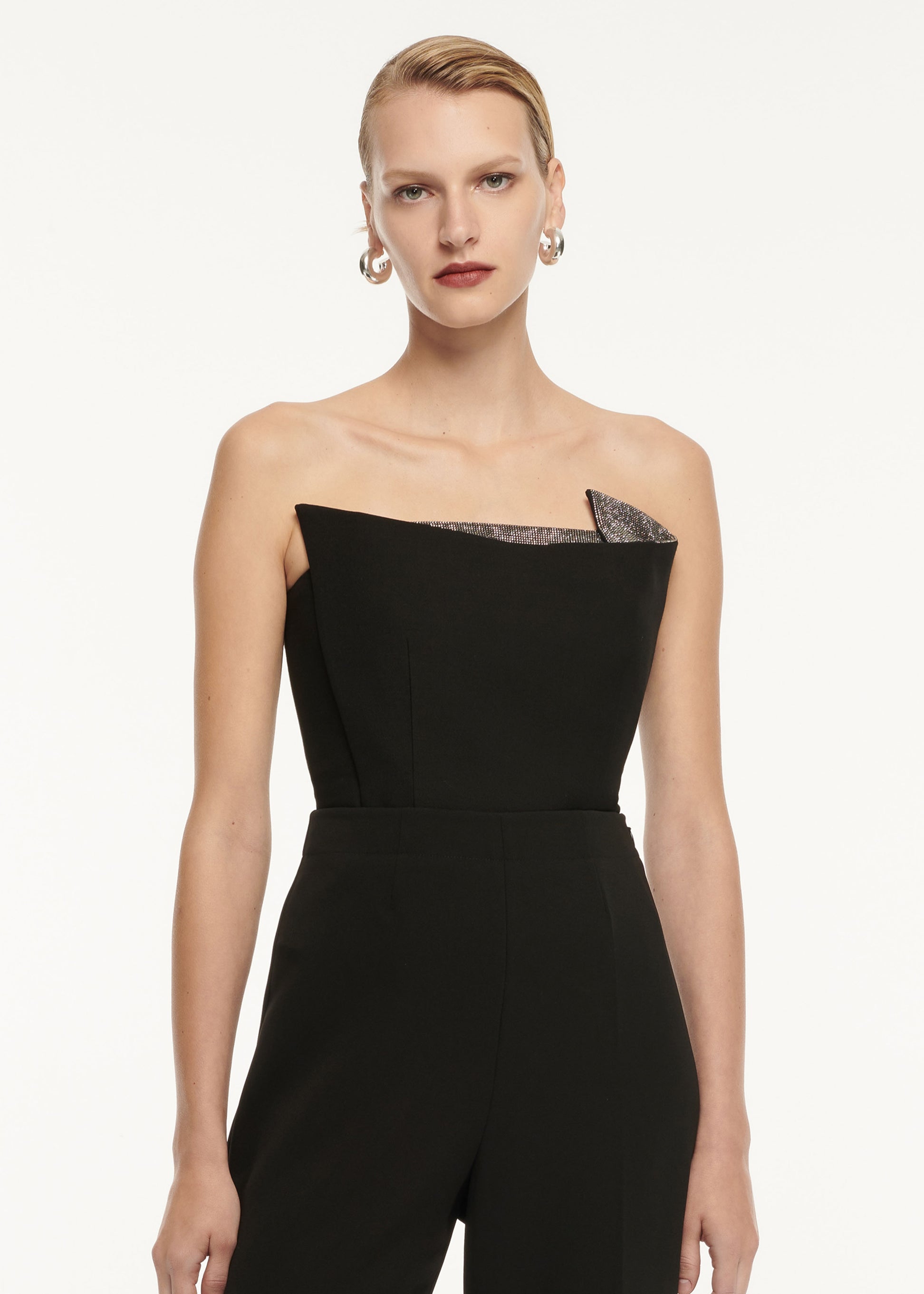 A close up of a woman wearing the Strapless Wool Silk Embellished Top