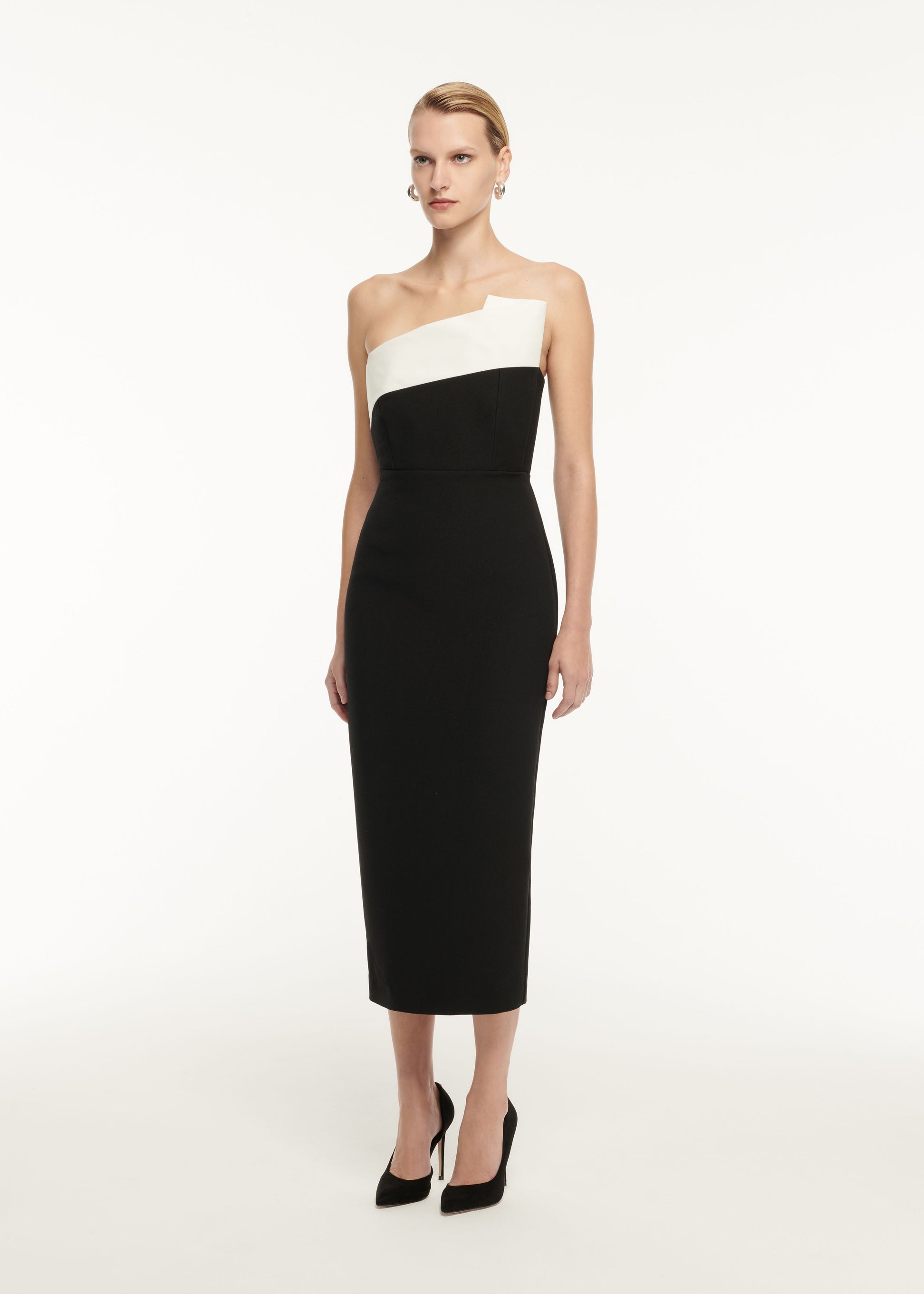 Side view of a model wearing the Strapless Drape Detail Crepe Midi Dress in Monochrome