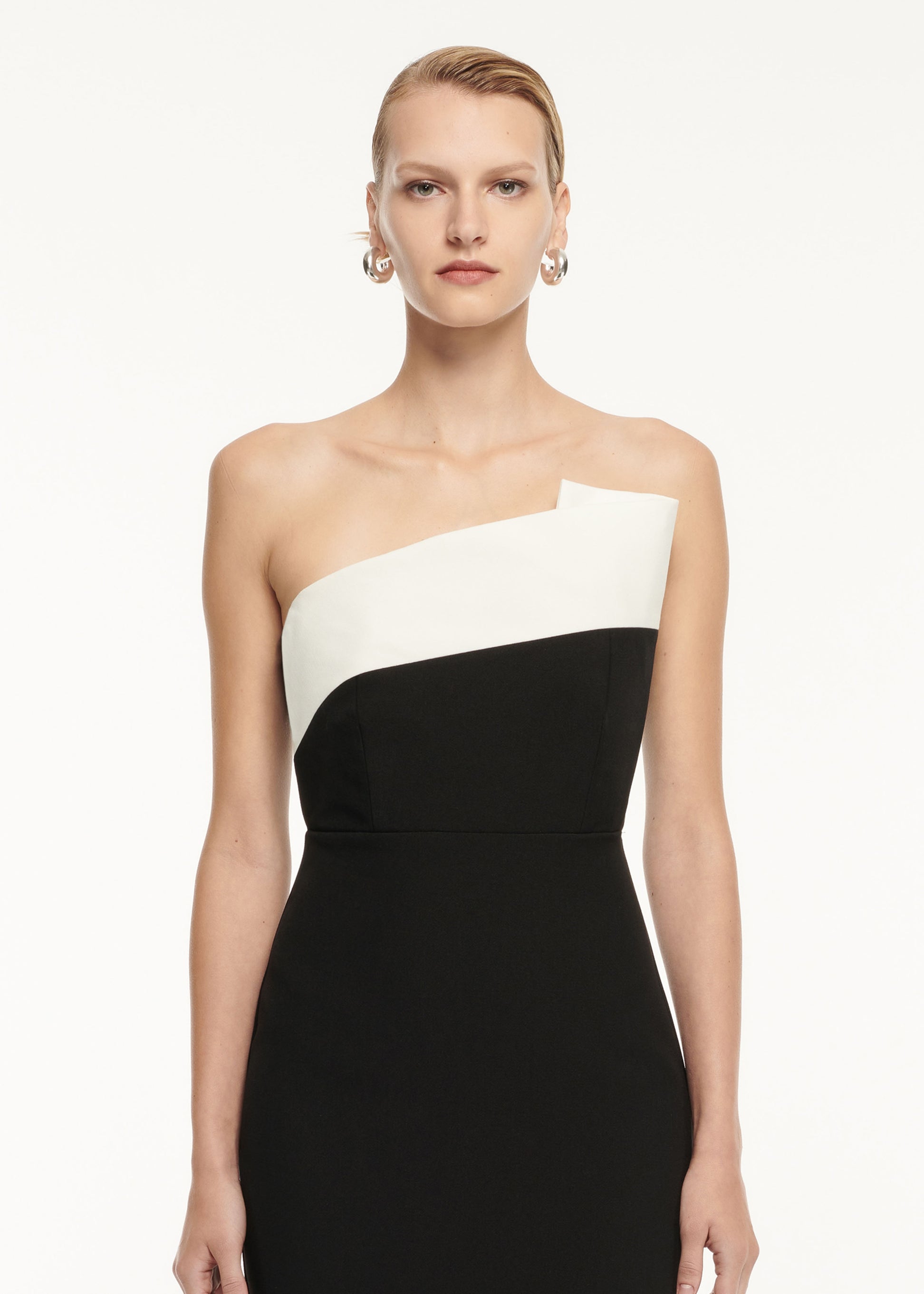 Close up of a model wearing the Strapless Drape Detail Crepe Midi Dress in Monochrome