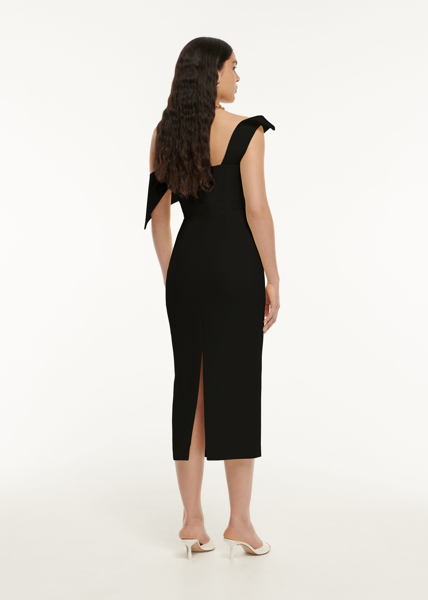 The back of a woman wearing the Asymmetric Drape Wool Silk Midi Dress