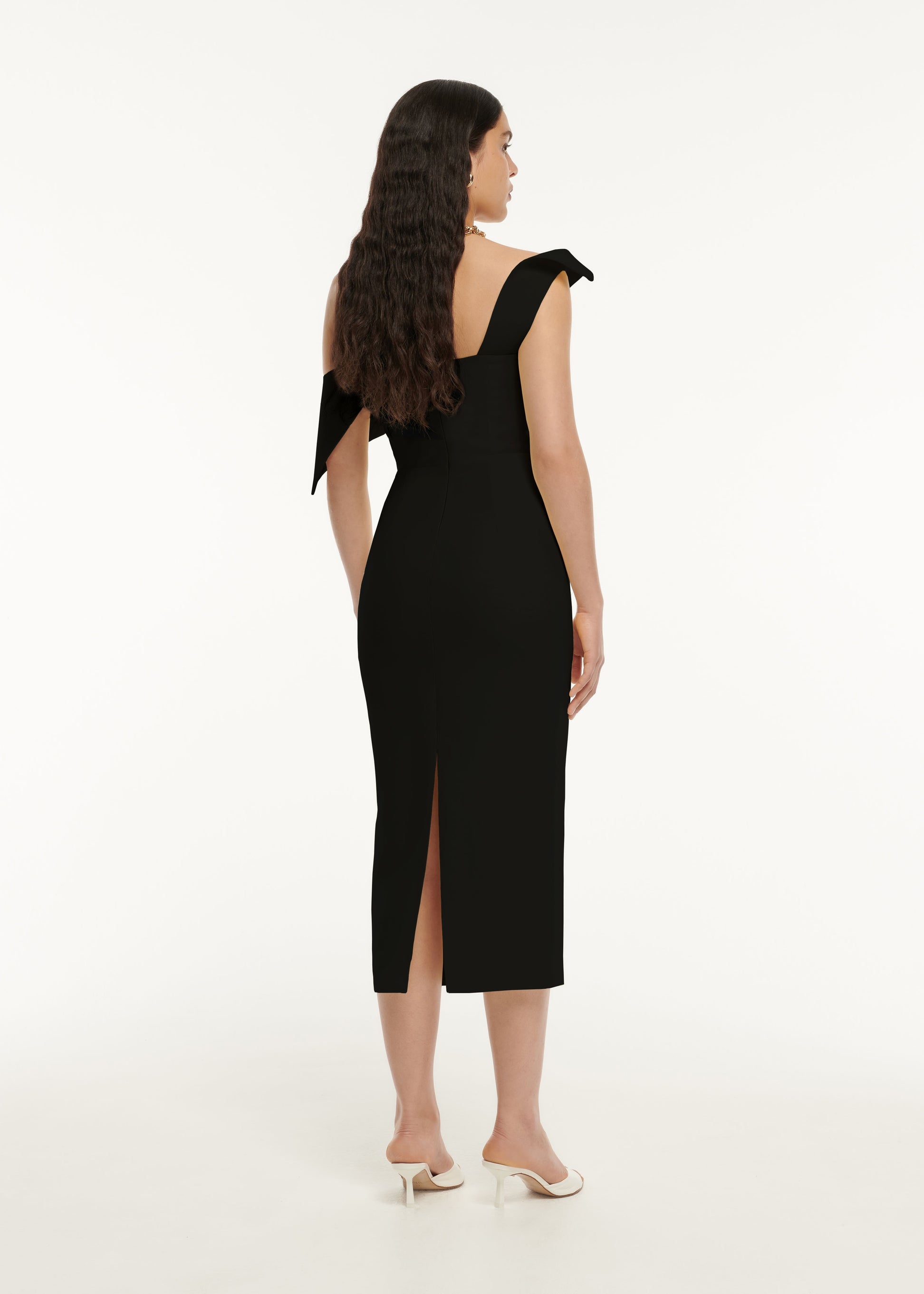 The back of a woman wearing the Asymmetric Drape Wool Silk Midi Dress