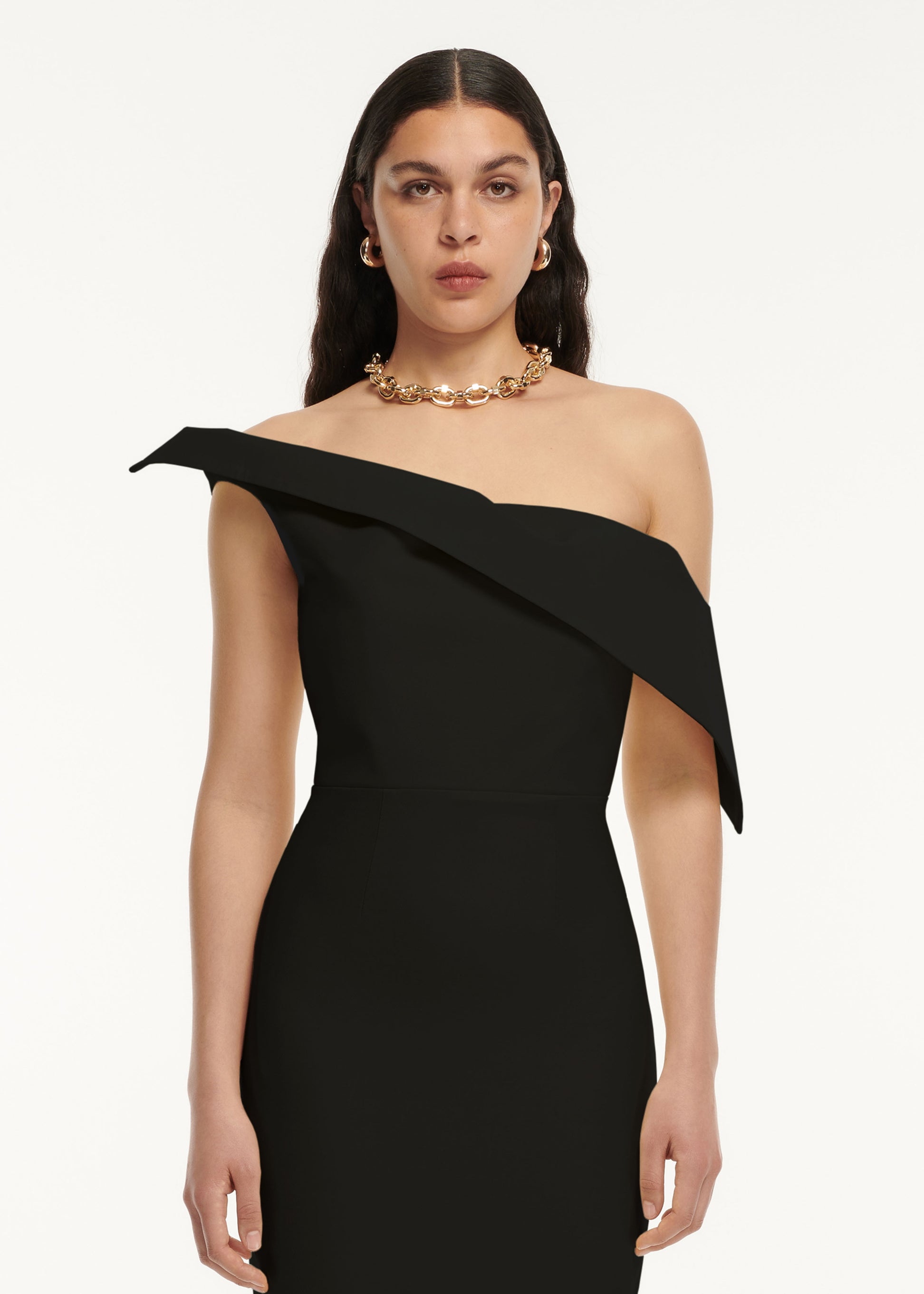 A close up of a woman wearing the Asymmetric Drape Wool Silk Midi Dress