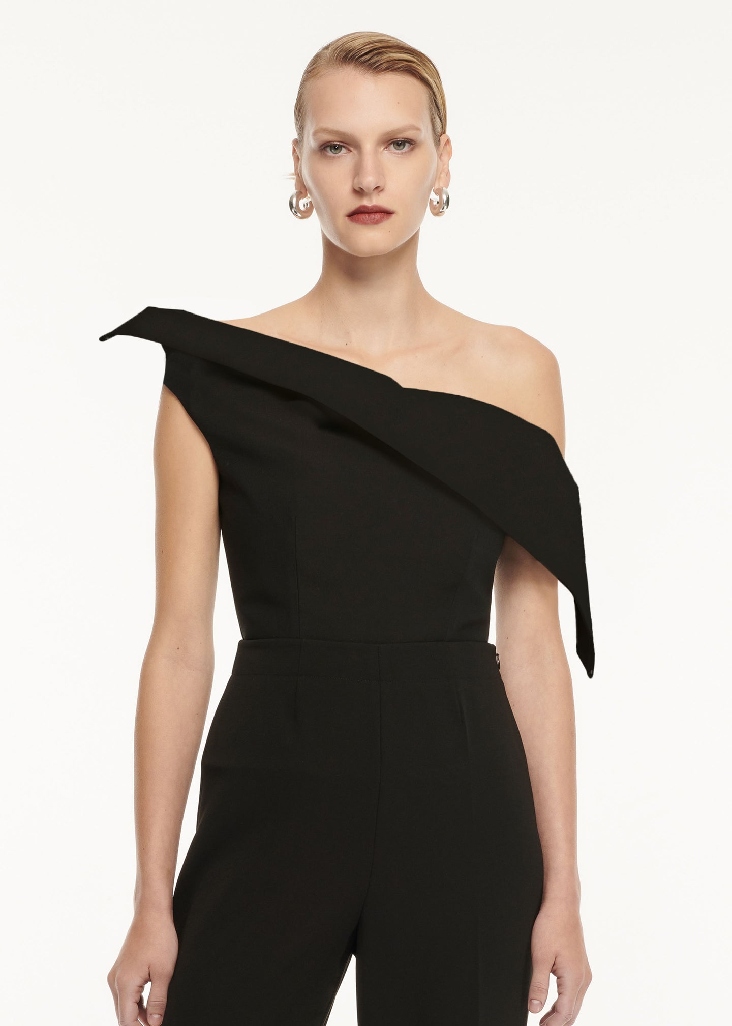 A close up of a woman wearing the Asymmetric Drape Wool Silk Top