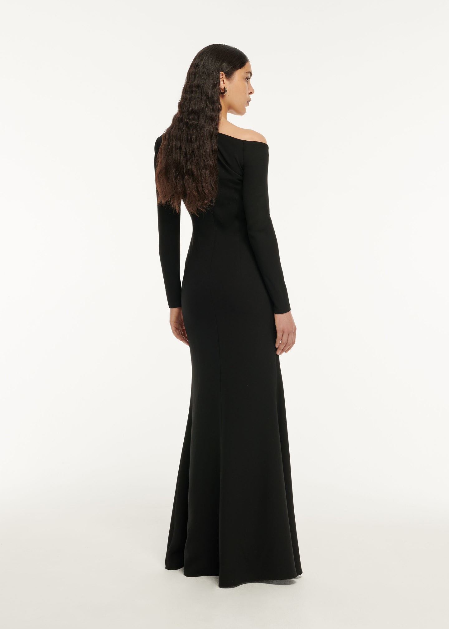 The back of a woman wearing the Asymmetric Satin Sash Maxi Dress