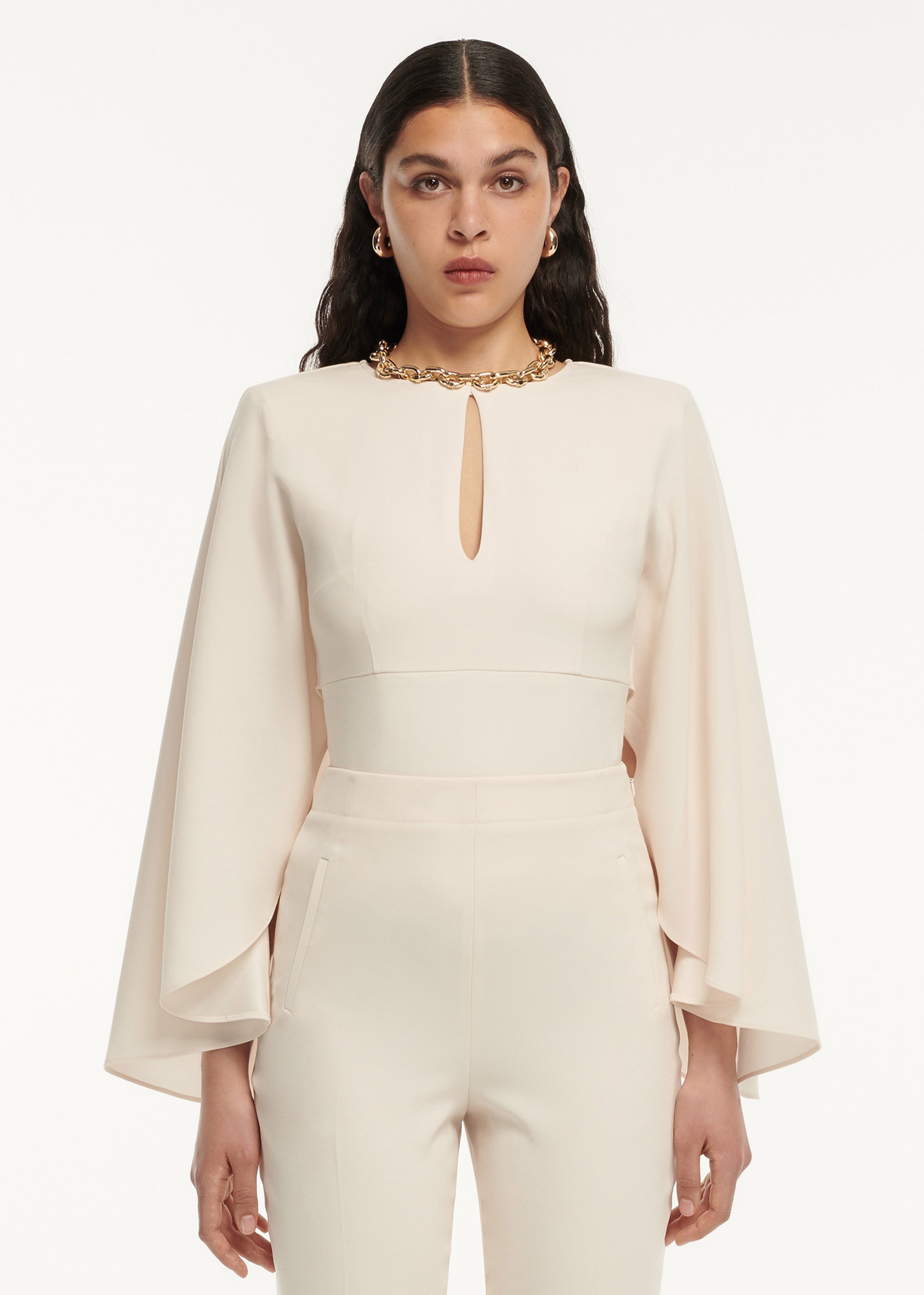 A close up of a woman wearing the Long Sleeve Satin Crepe Top