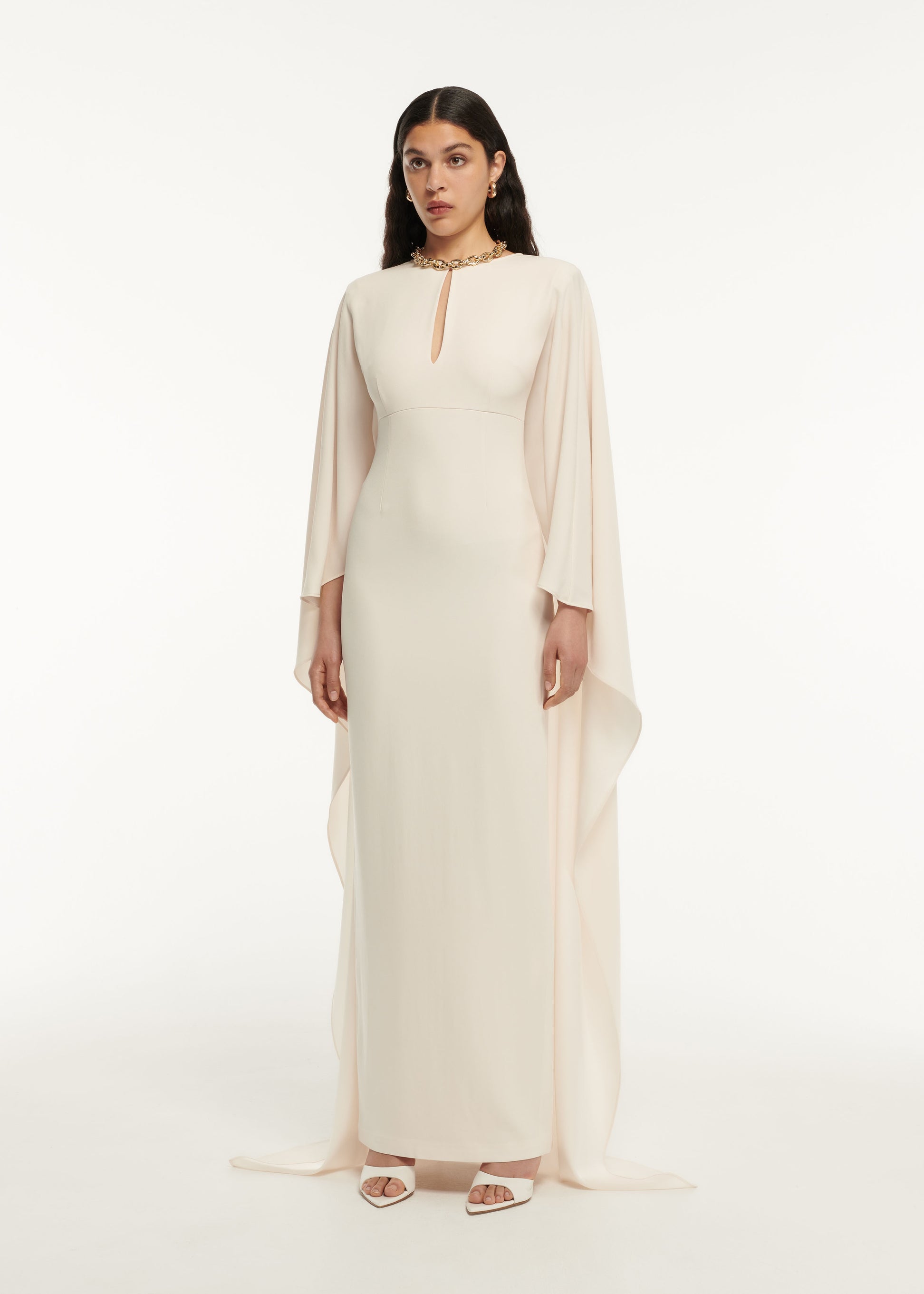 A woman wearing the Long Sleeve Satin Crepe Maxi Dress in Cream