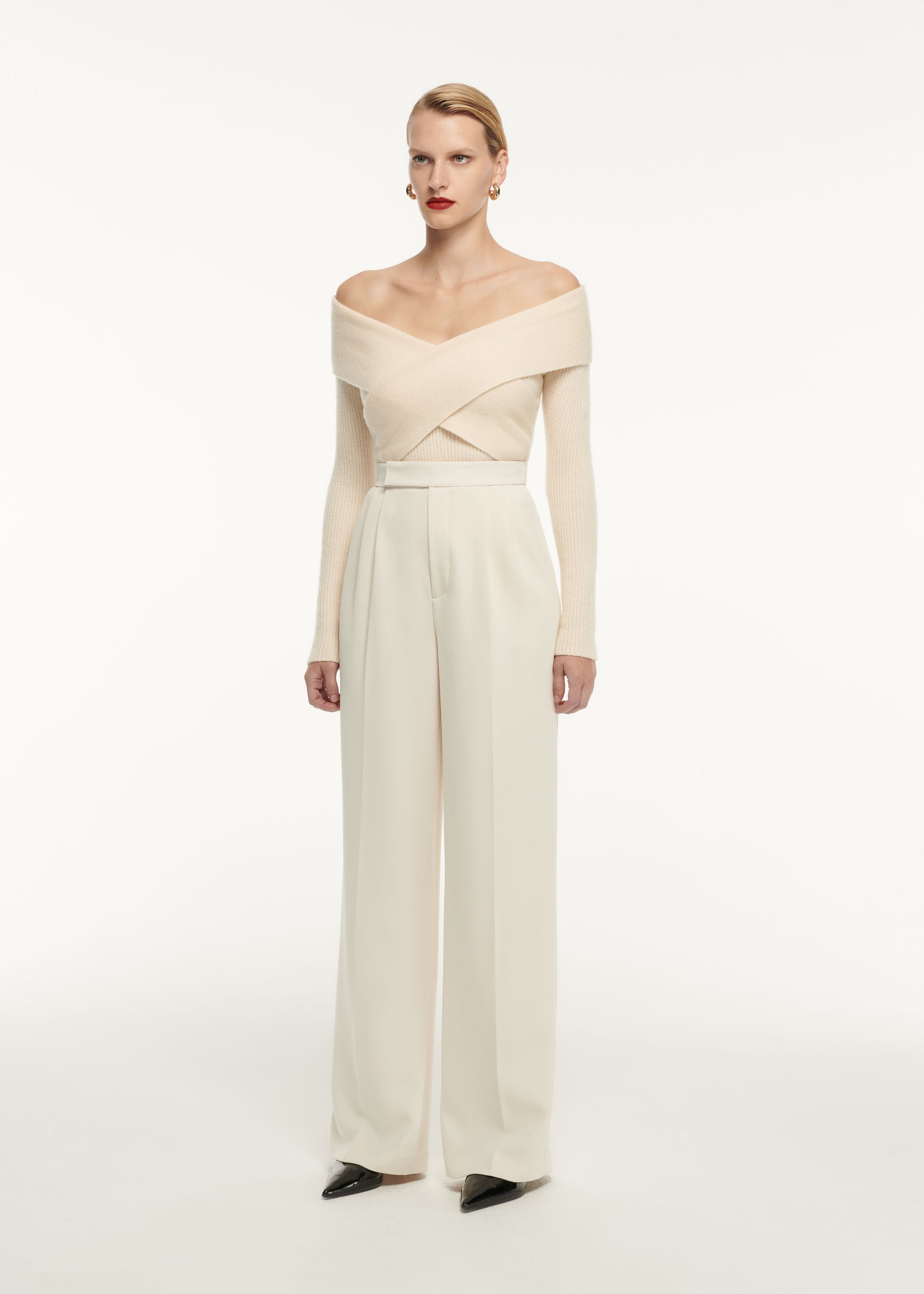 A woman wearing the Long Sleeve Cashmere Top in Cream