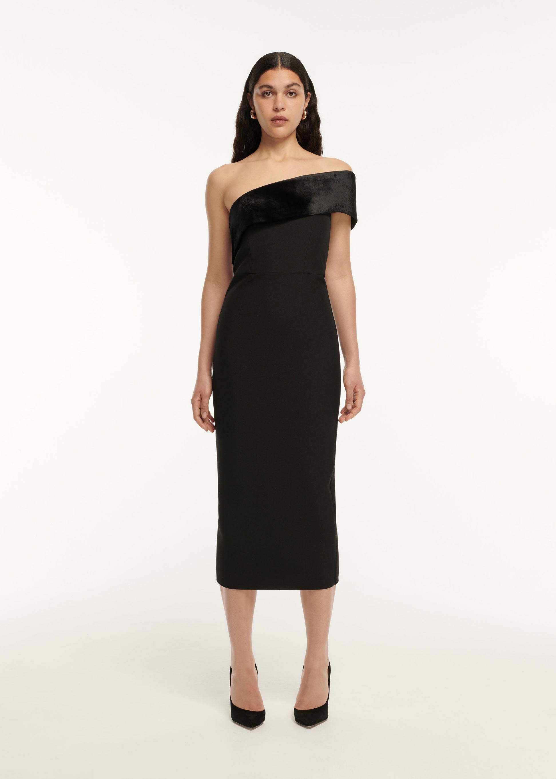 A woman wearing the Asymmetric Stretch Cady Midi Dress in Black