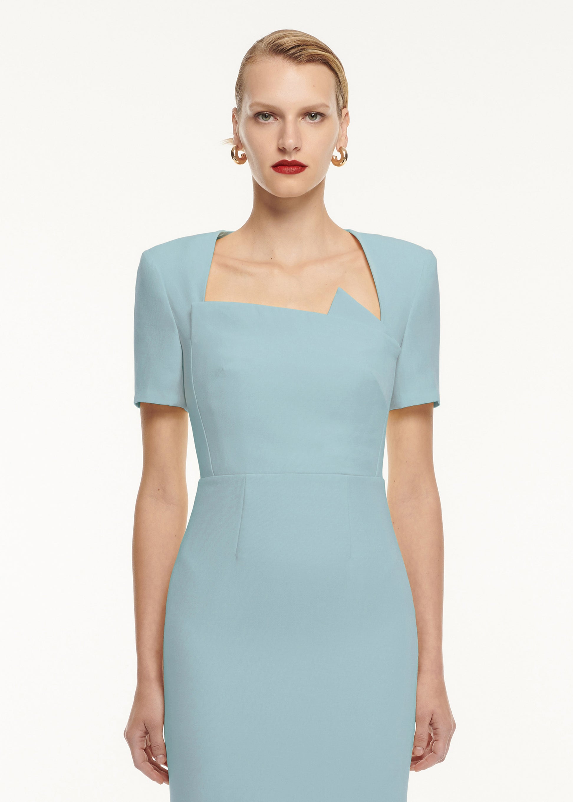 A close up of a woman wearing the Short Sleeve Pleat Detail Wool Silk Midi Dress