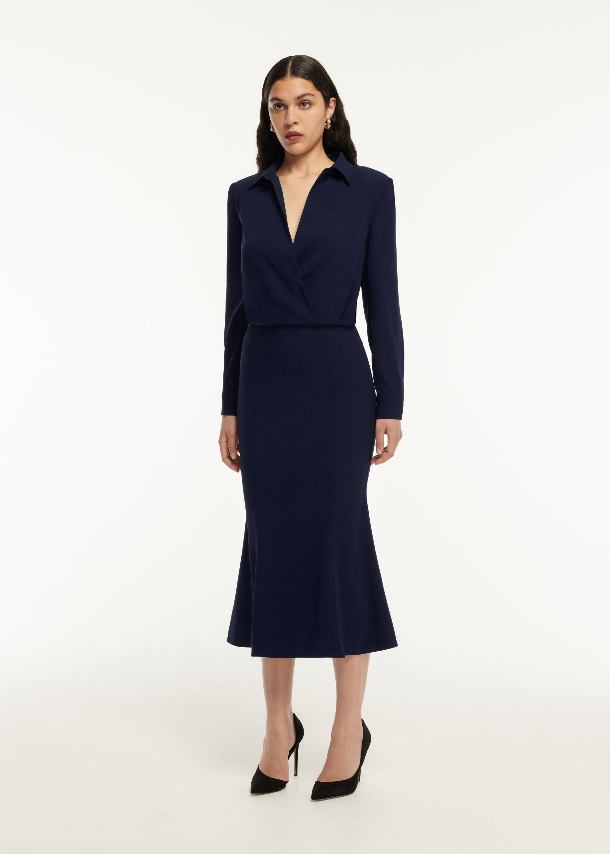 A woman wearing the Long Sleeve Collar Satin Crepe Midi Dress in Navy