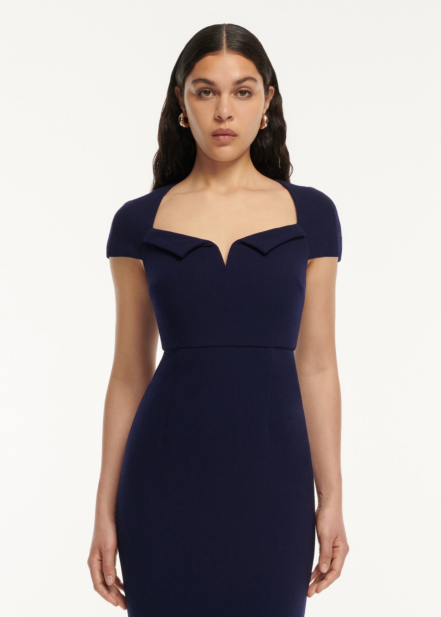 A close up of a woman wearing the Cap Sleeve Fitted Wool Crepe Midi Dress