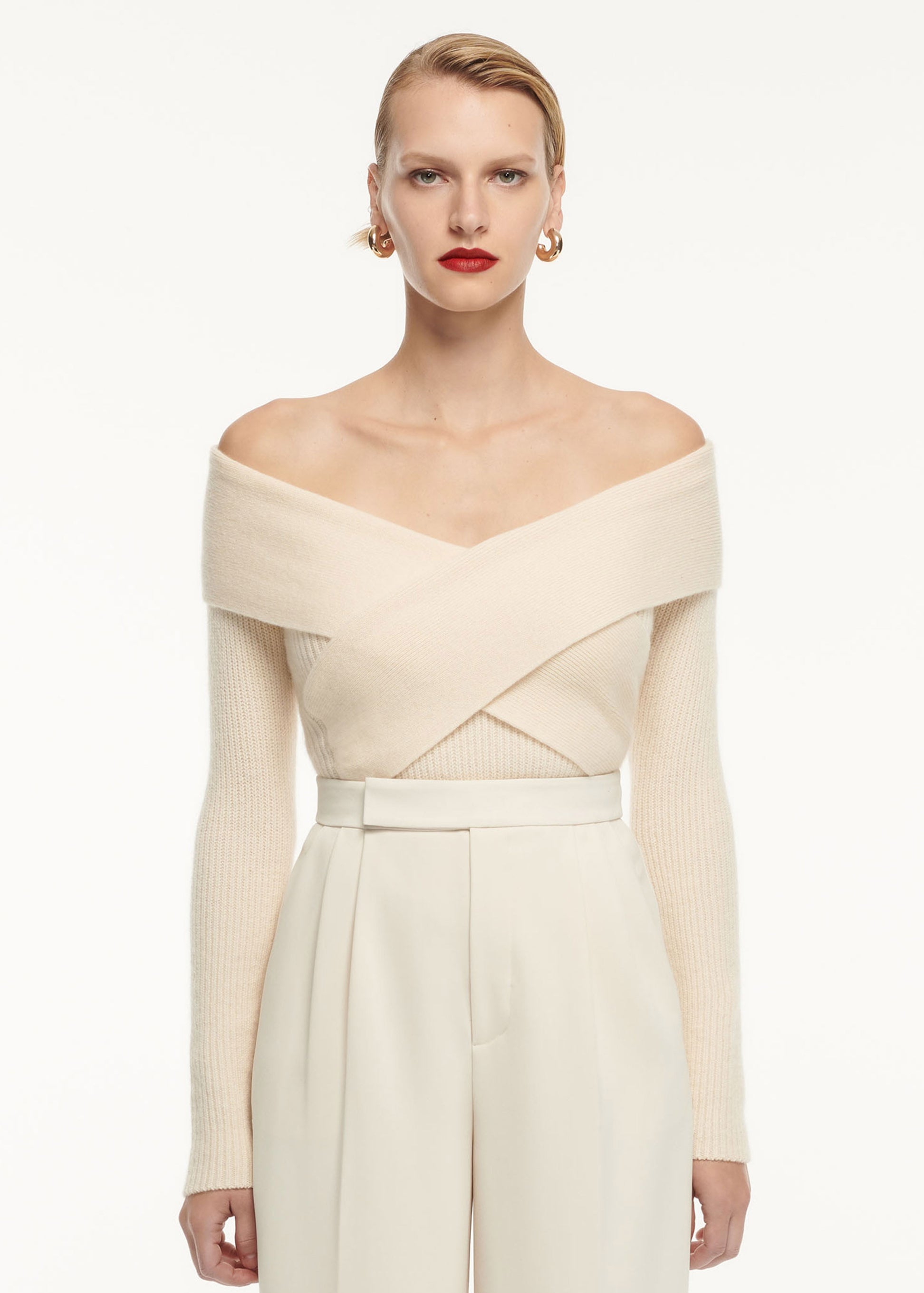 A close up of a woman wearing the Wide Leg Stretch Cady Trouser Cream