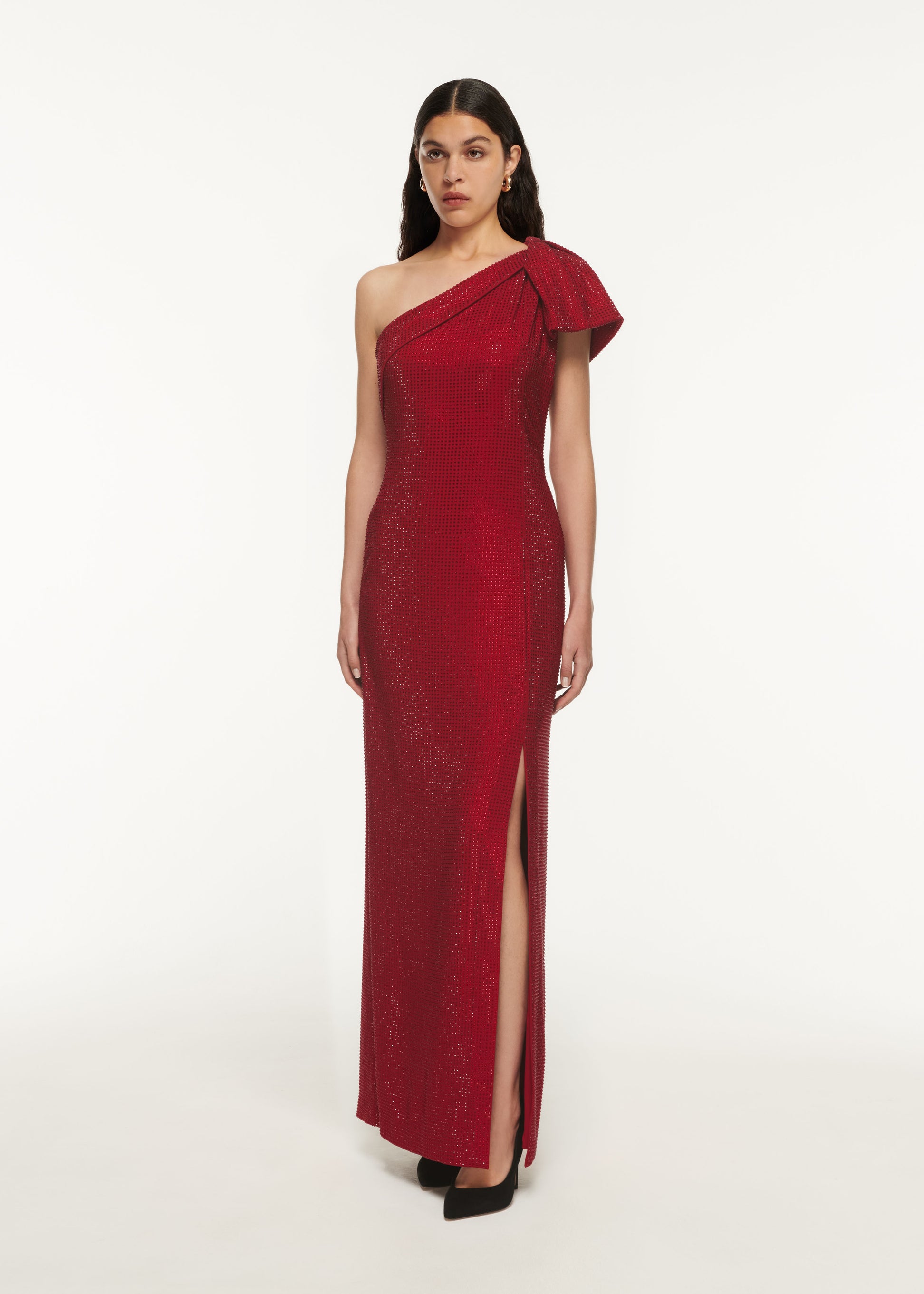 A woman wearing the Asymmetric Diamante Maxi Dress