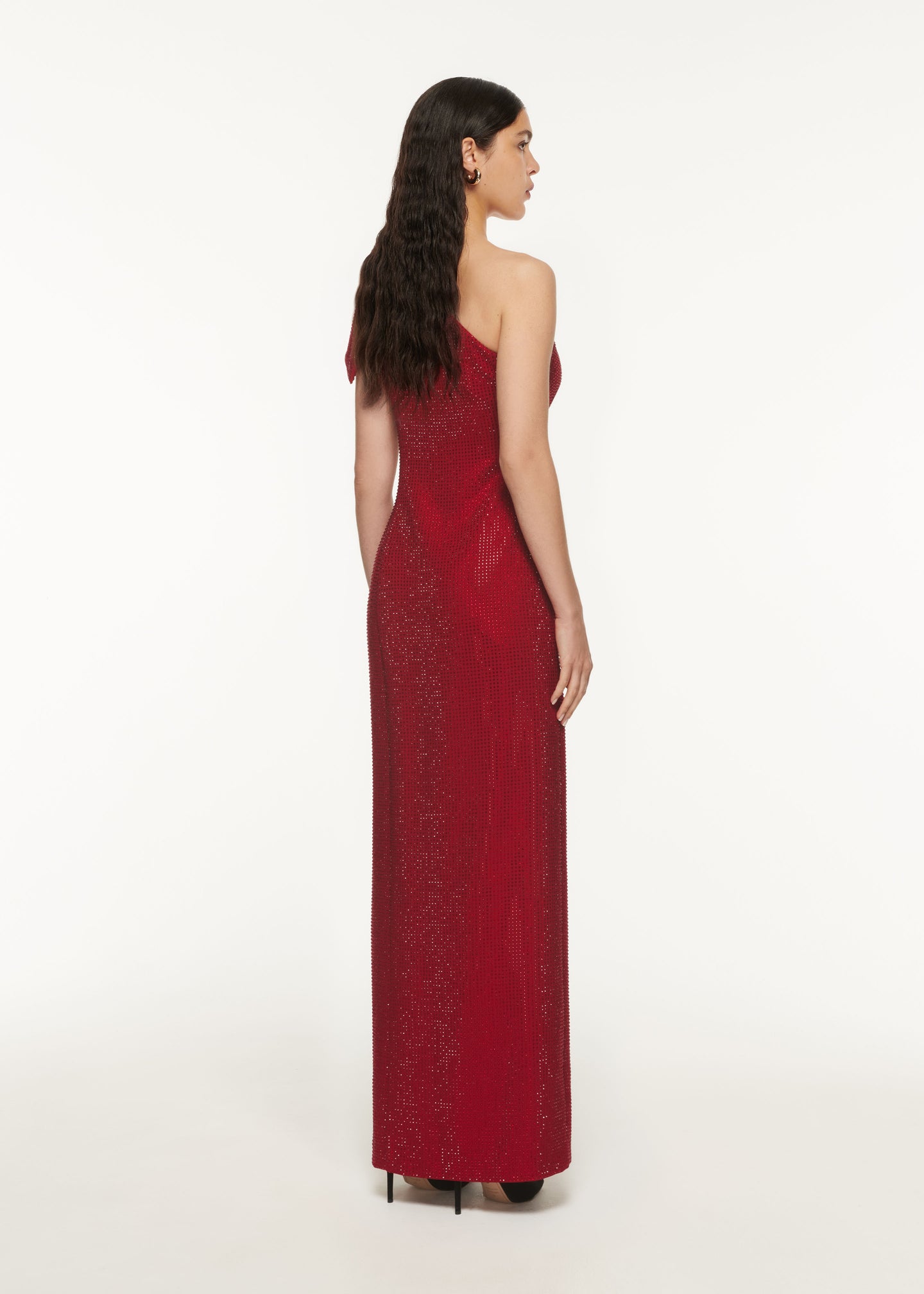 The back of a woman wearing the Asymmetric Diamante Maxi Dress