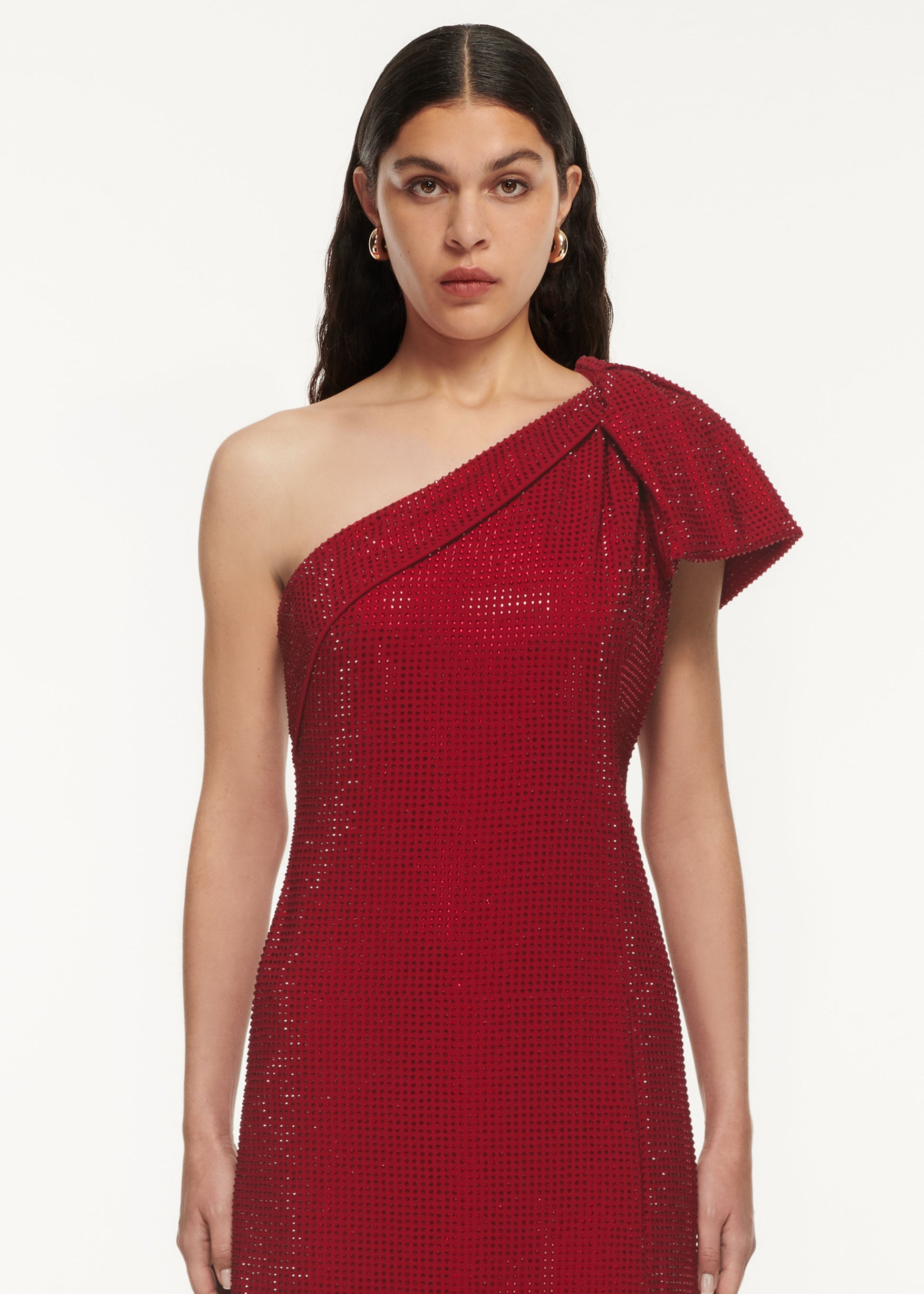 A close up of a woman wearing the Asymmetric Diamante Maxi Dress